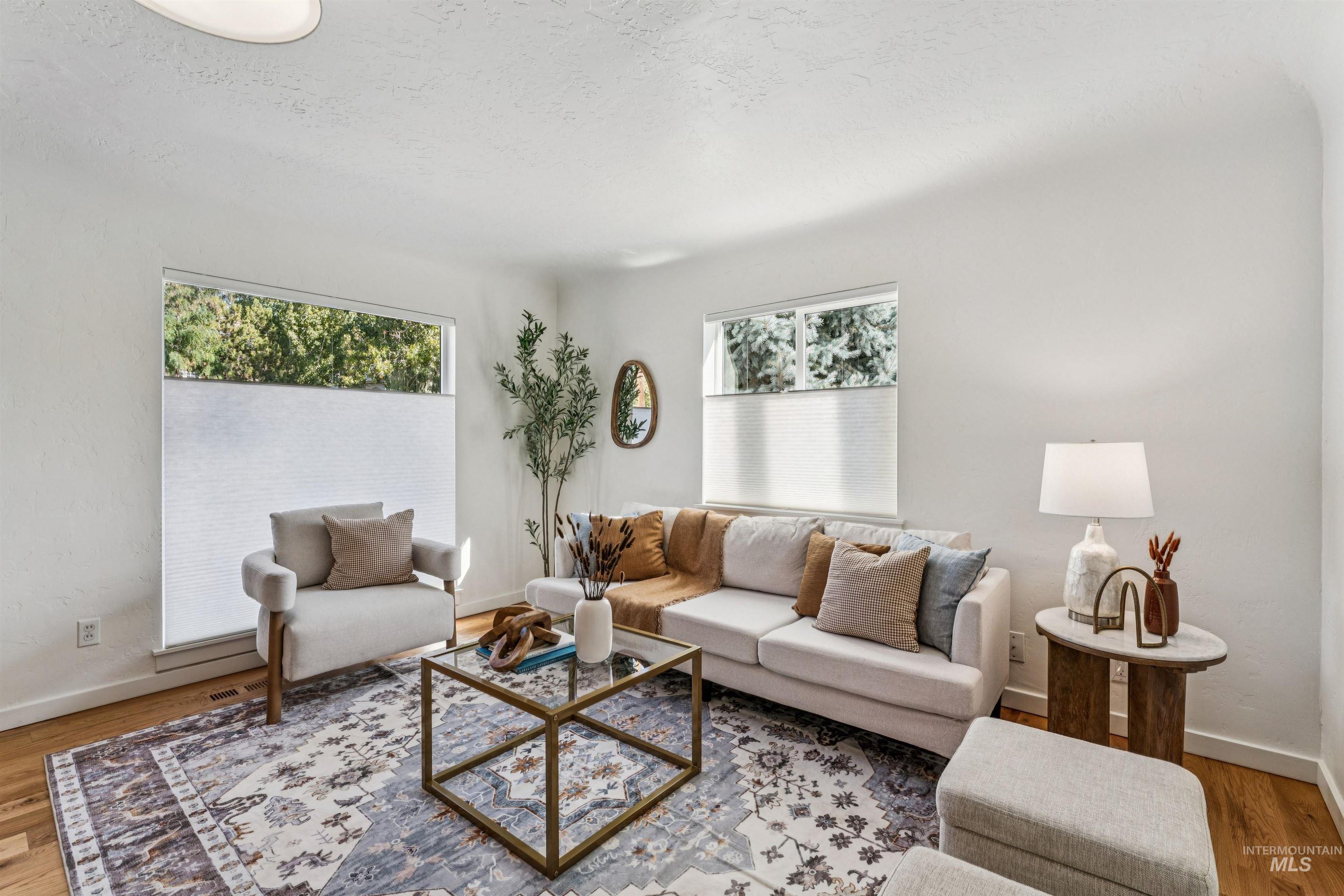 Great room with wood finished floors and a textured ceiling