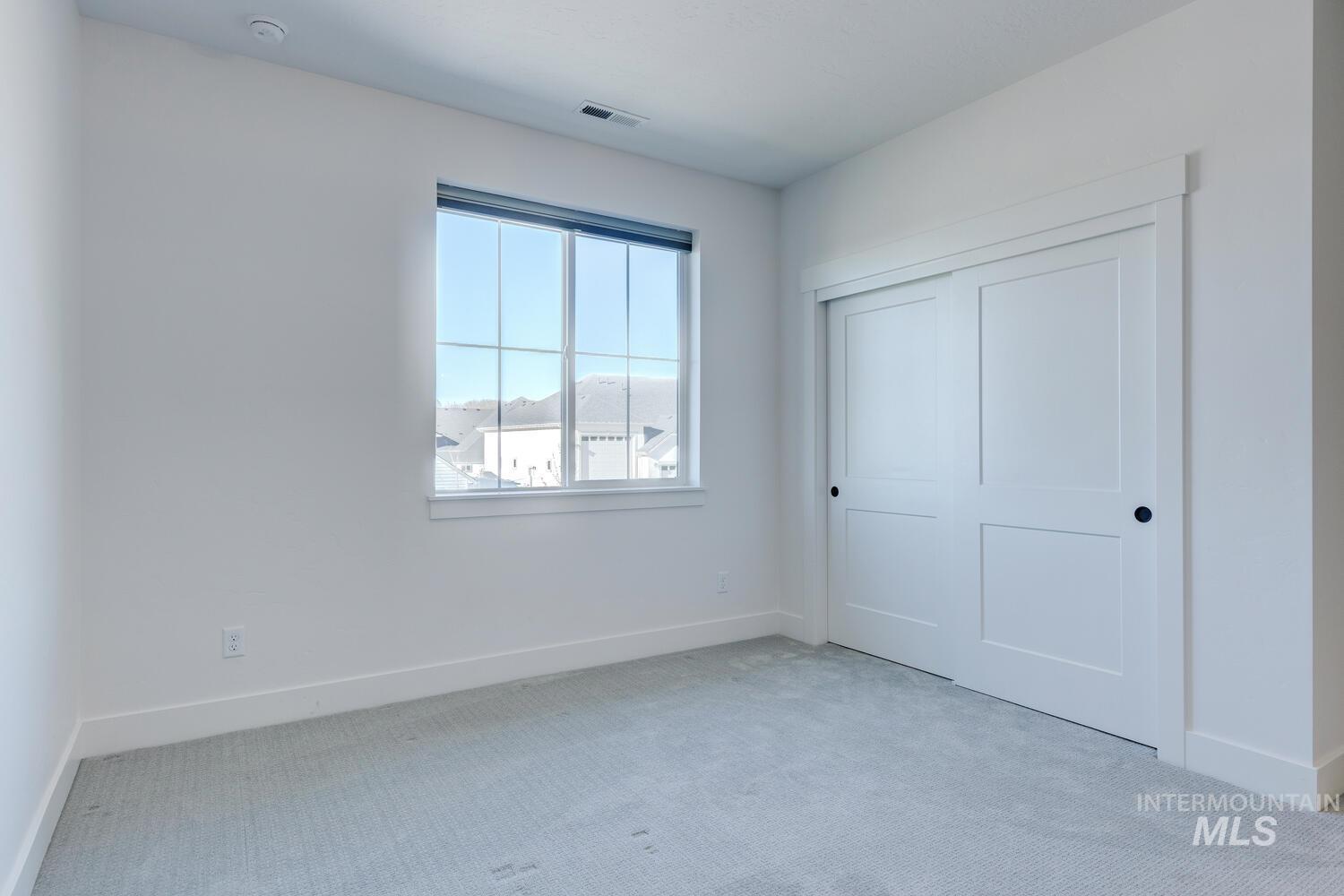 Unfurnished bedroom with carpet flooring and a closet
