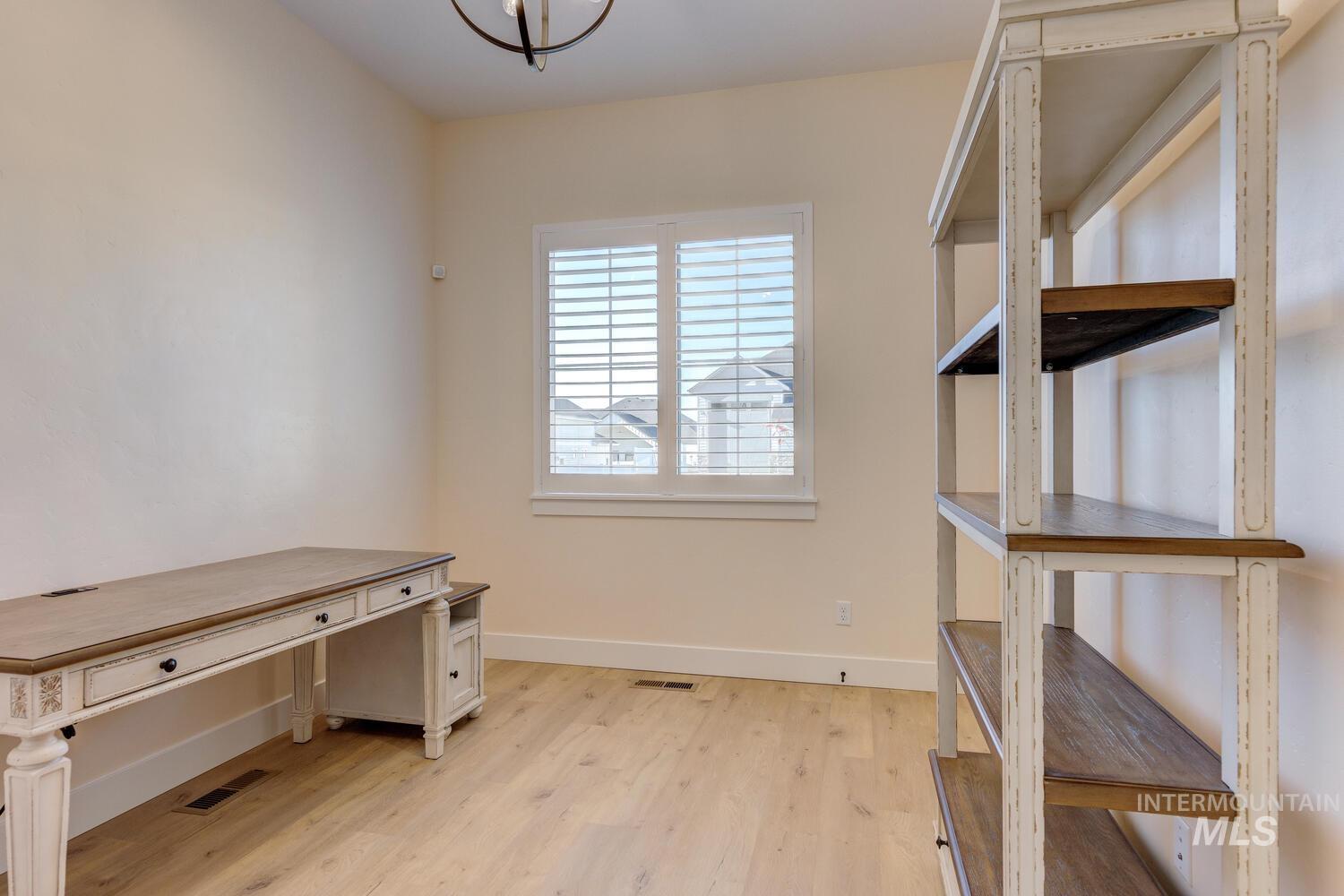 Unfurnished office featuring baseboards and light wood-type flooring