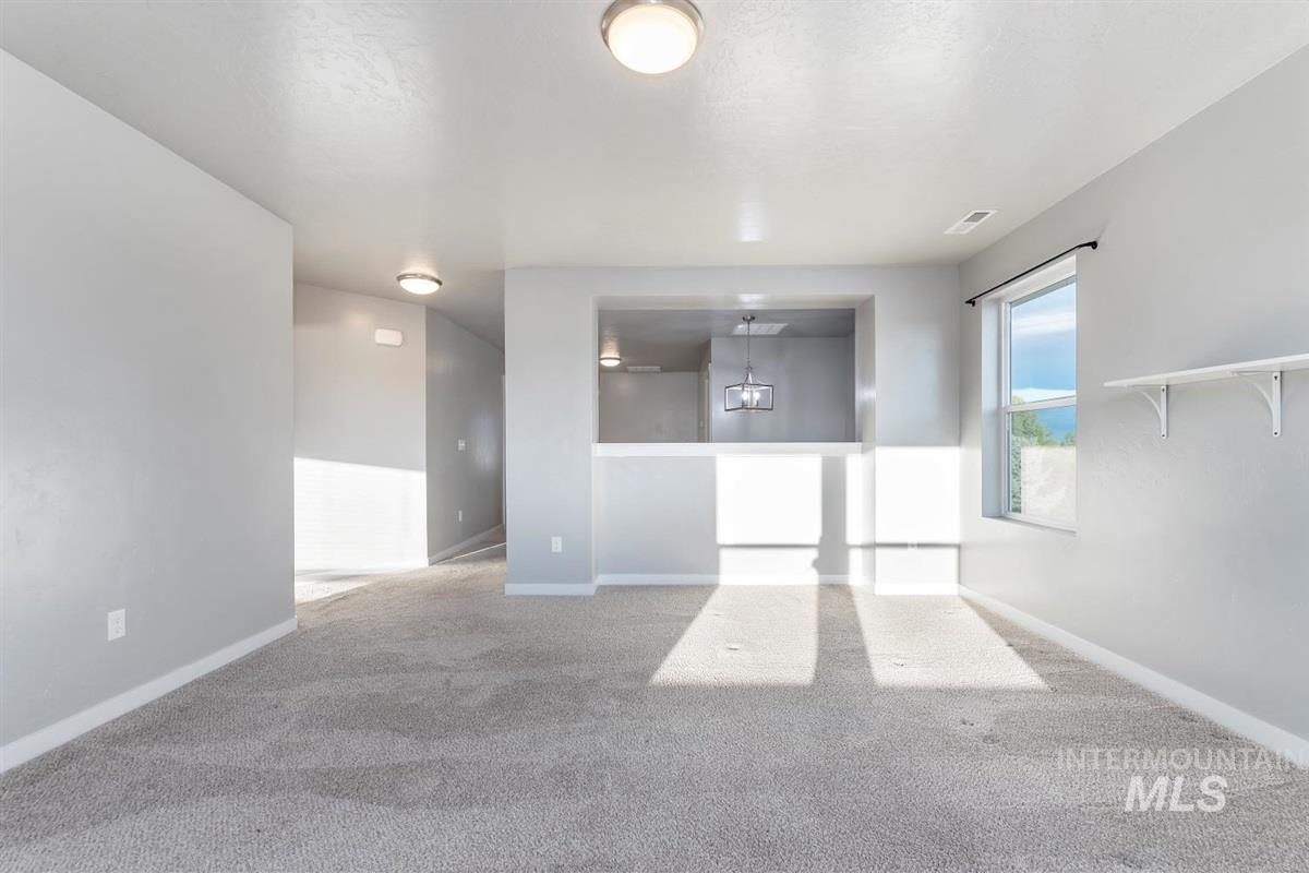 Empty room with carpet and baseboards