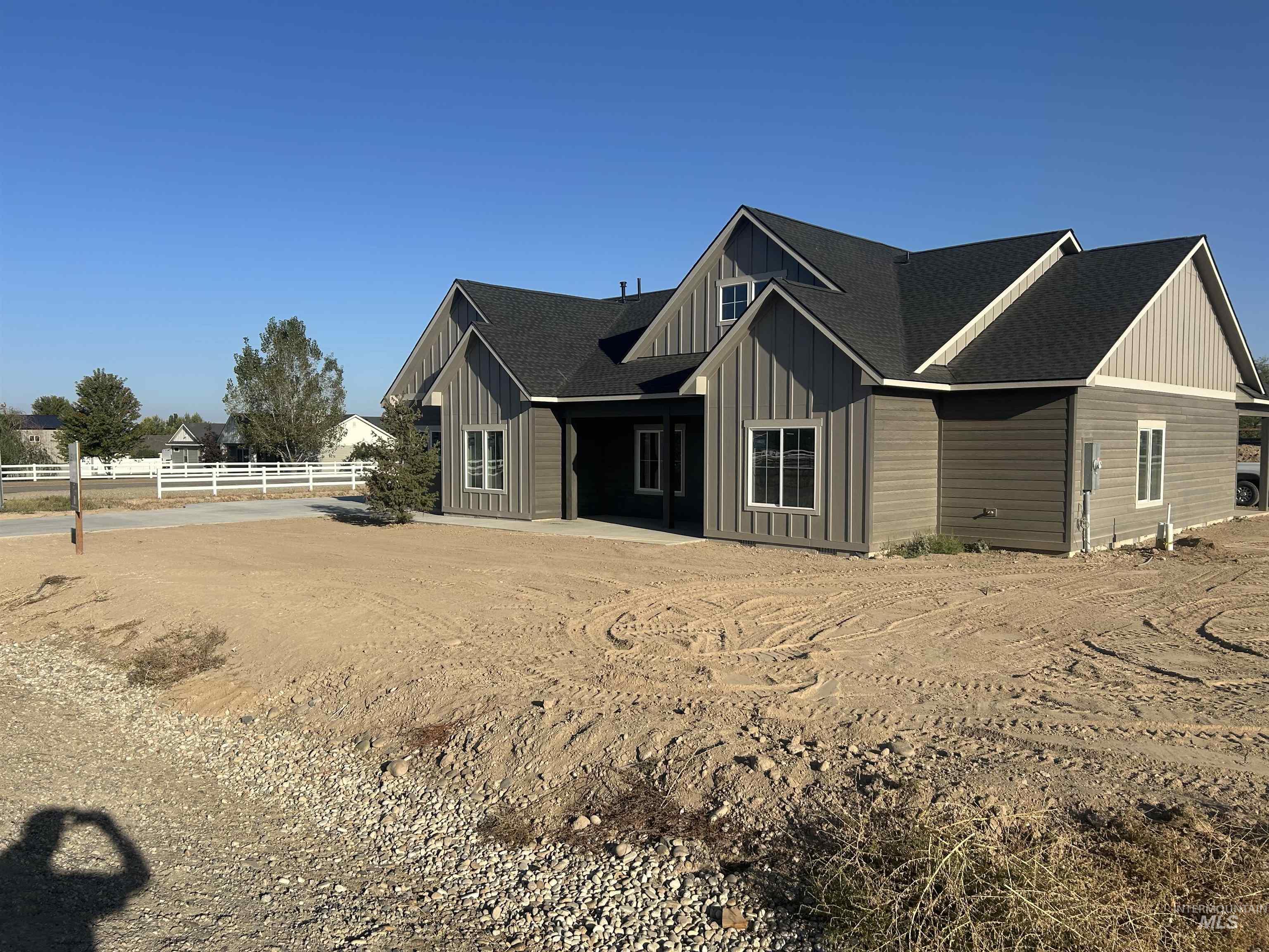 View of property exterior with roof with shingles and board and batten siding