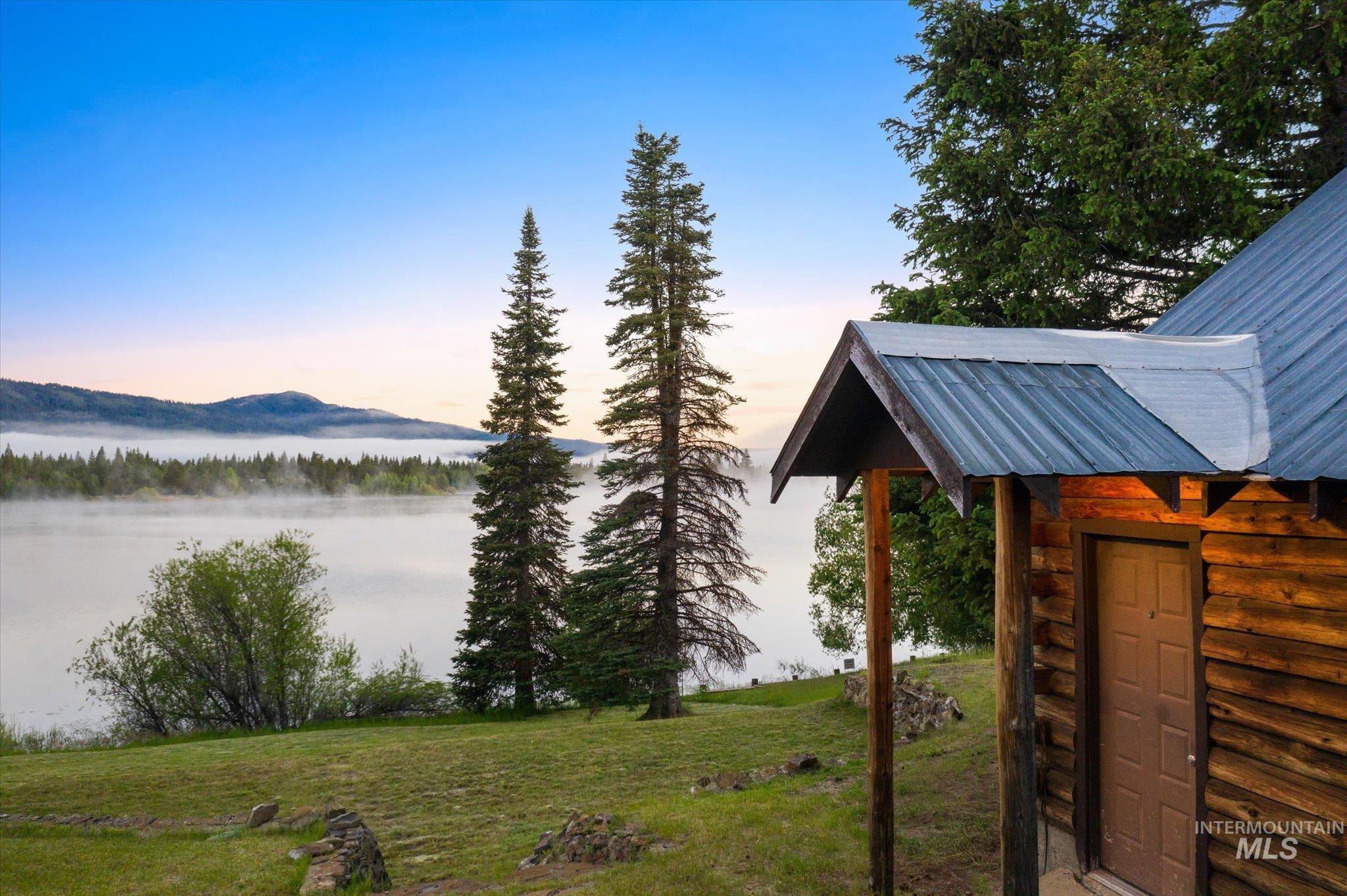 Rustic cabin exterior featuring natural wood siding and a metal roof