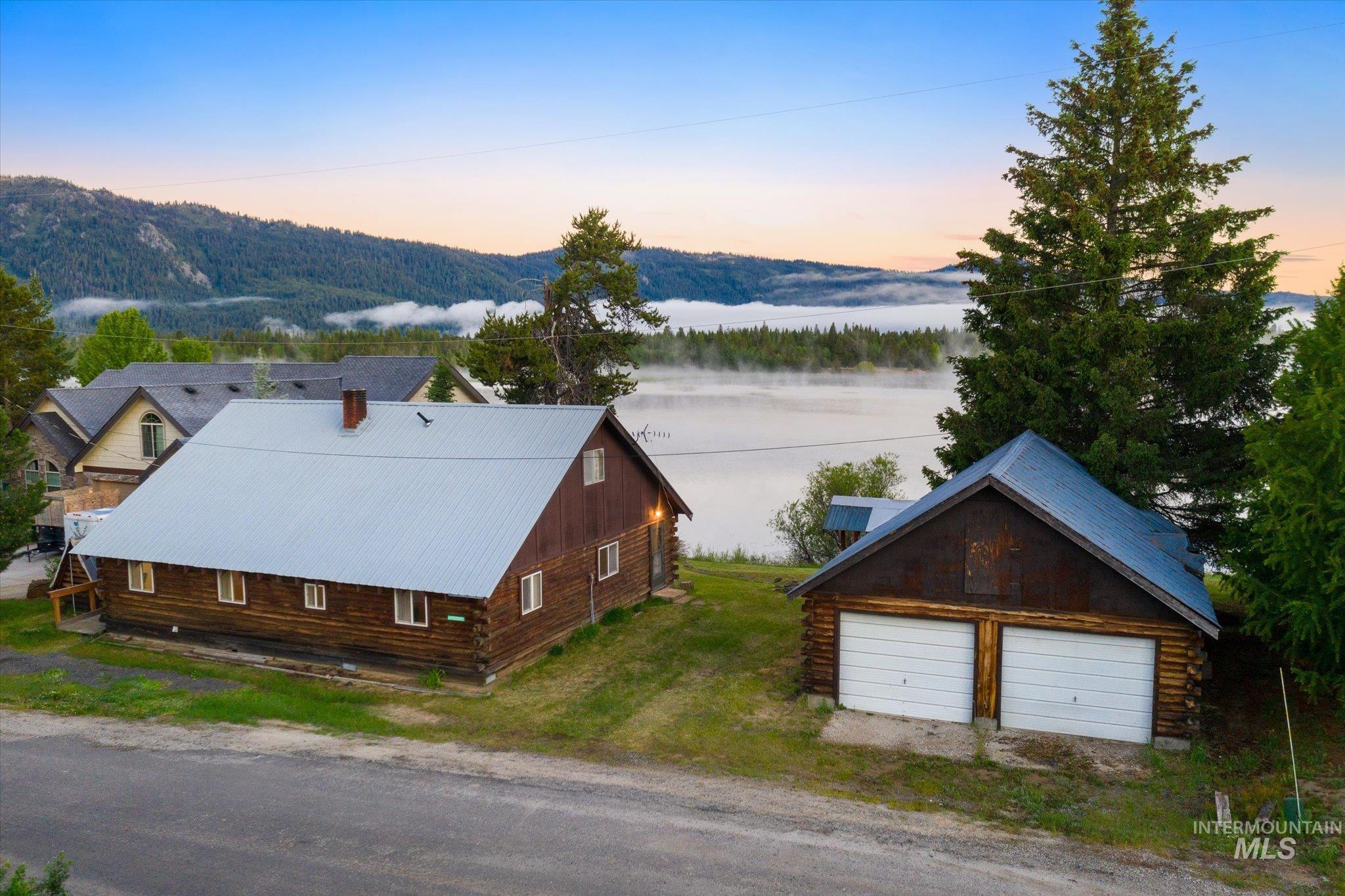 Wood-sided residence with a metal roof and a two-car detached garage