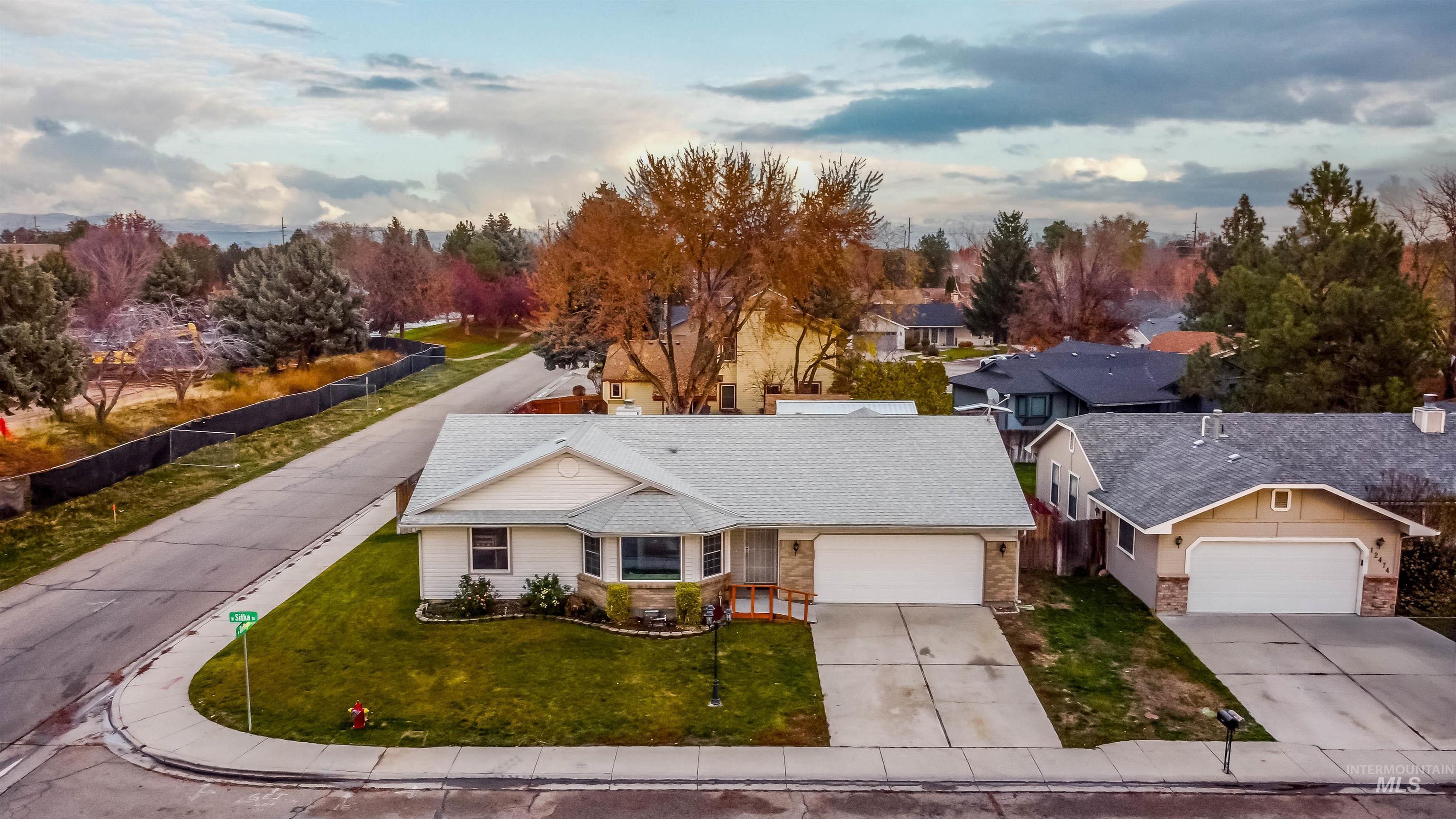 View of front facade featuring concrete driveway and stone siding