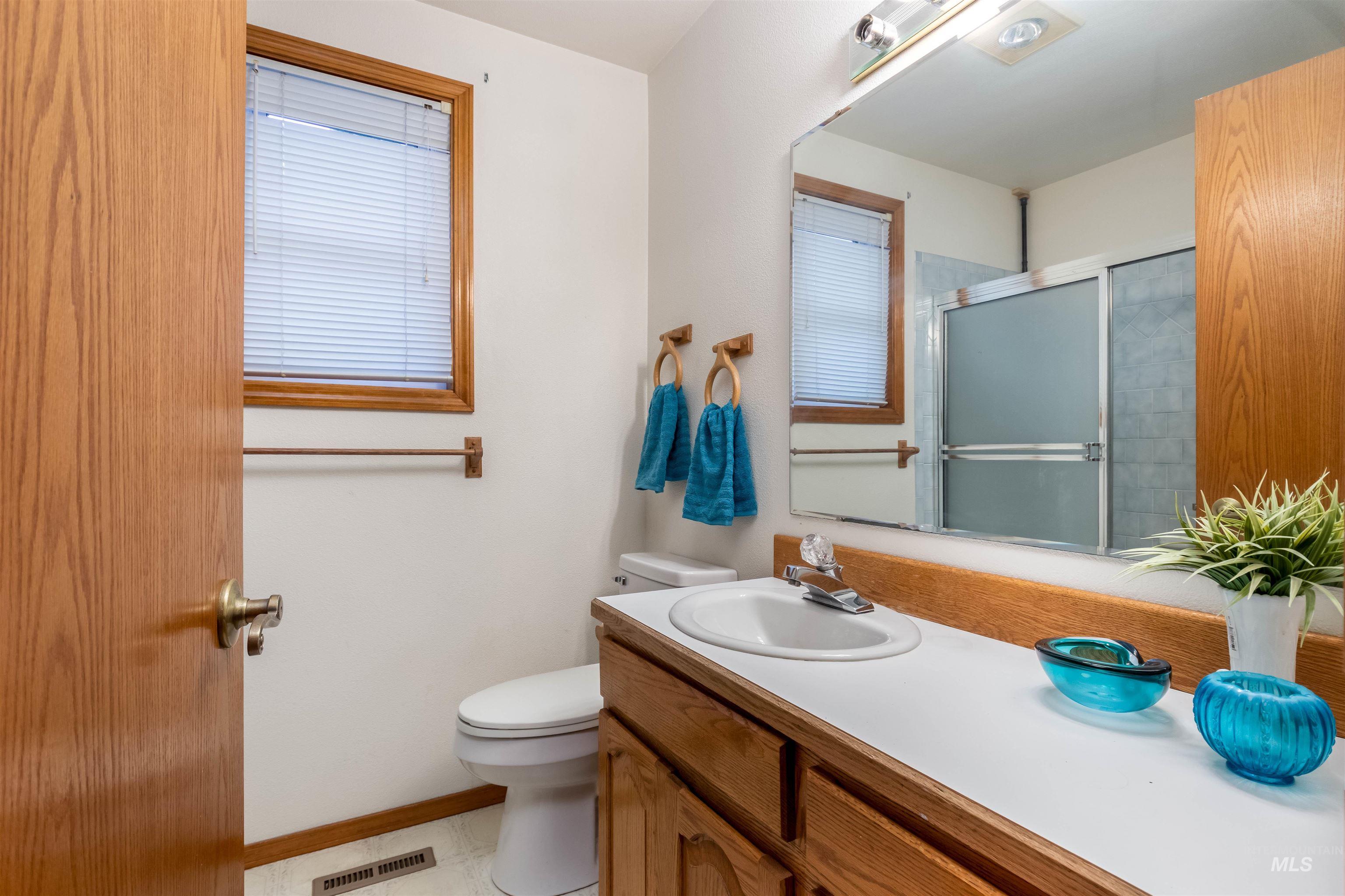 Bathroom with vanity and a shower with shower door