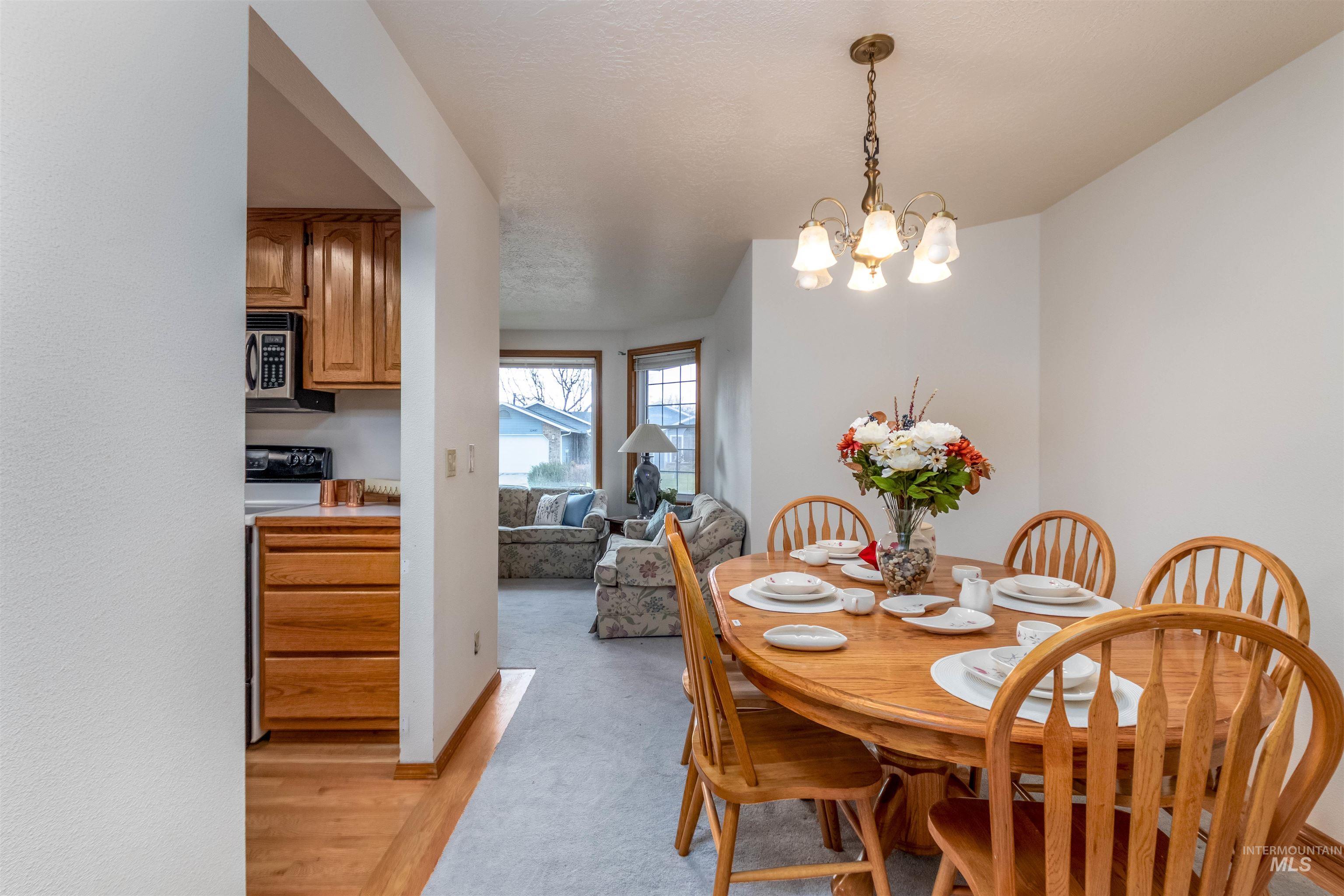 Dining space featuring a chandelier and light wood-type flooring
