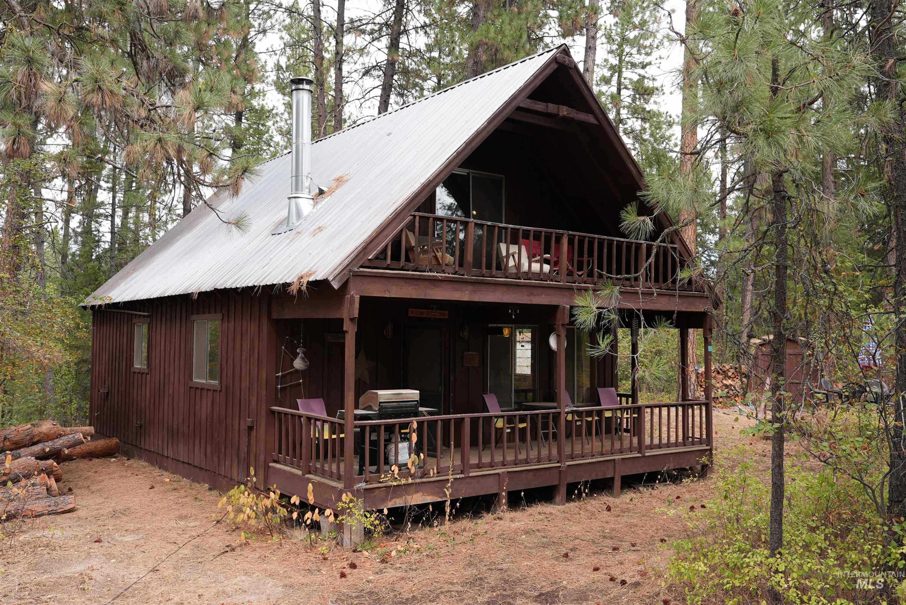 View of front facade with a deck, a metal roof, and a balcony