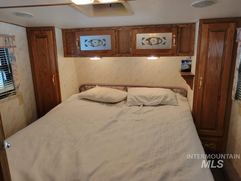 Bedroom featuring wallpapered walls