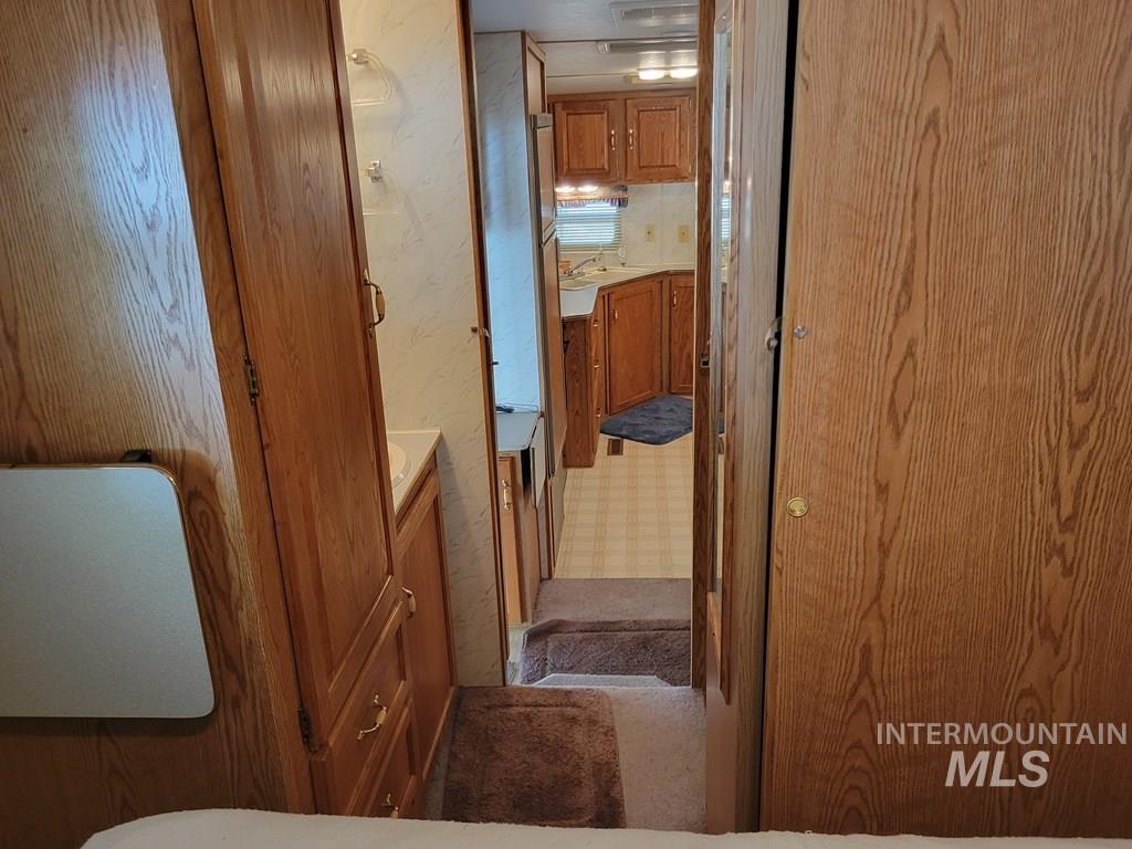 Bathroom featuring wallpapered walls and vanity