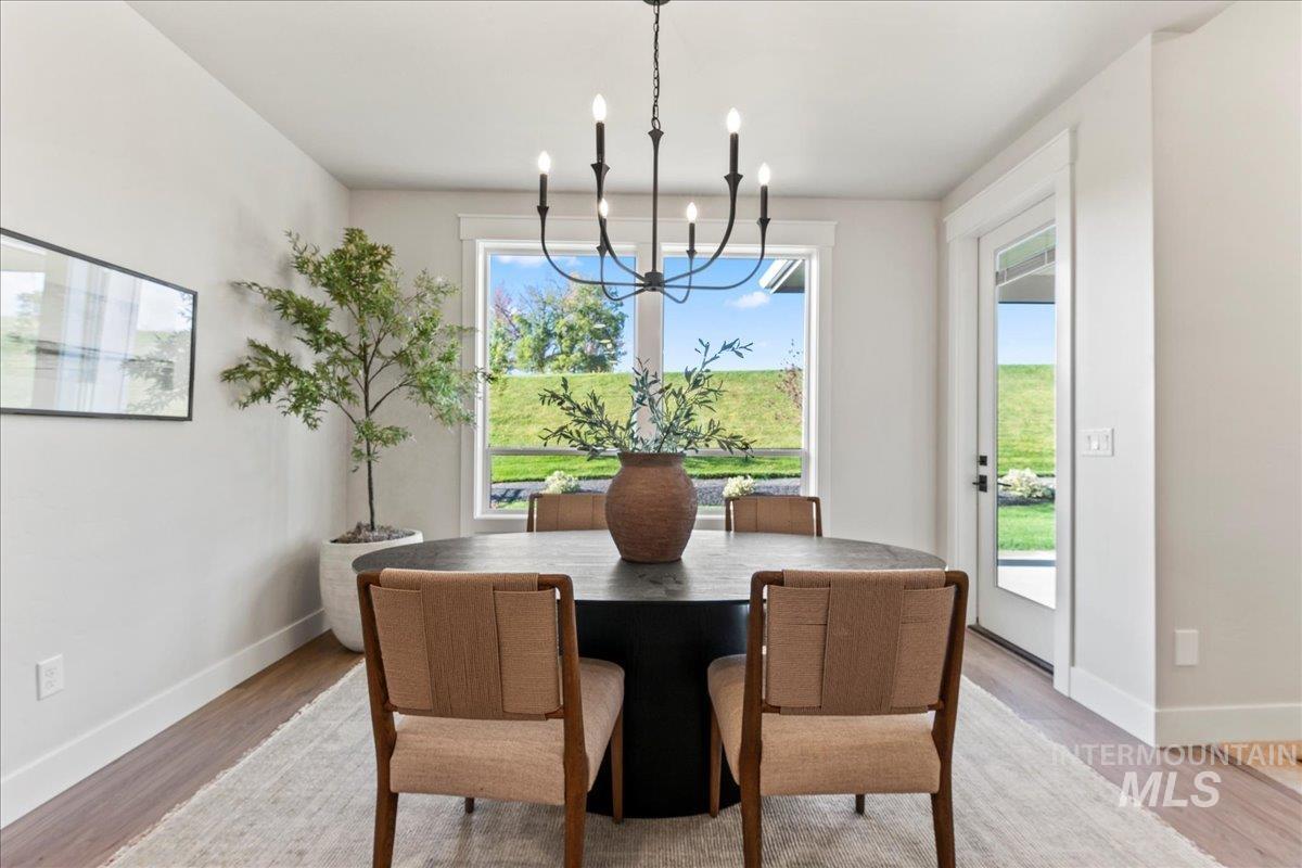 Dining room featuring light wood-type flooring and a chandelier