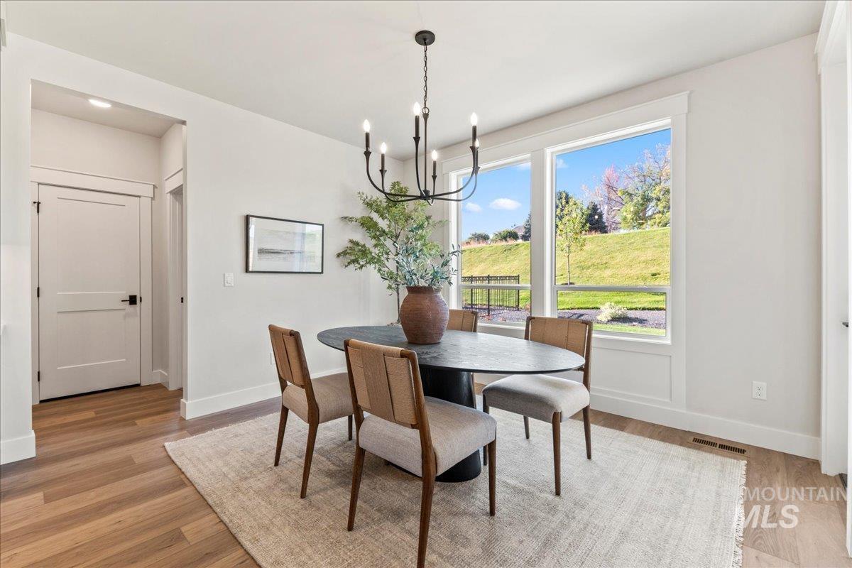 Dining area with a chandelier and light wood finished floors