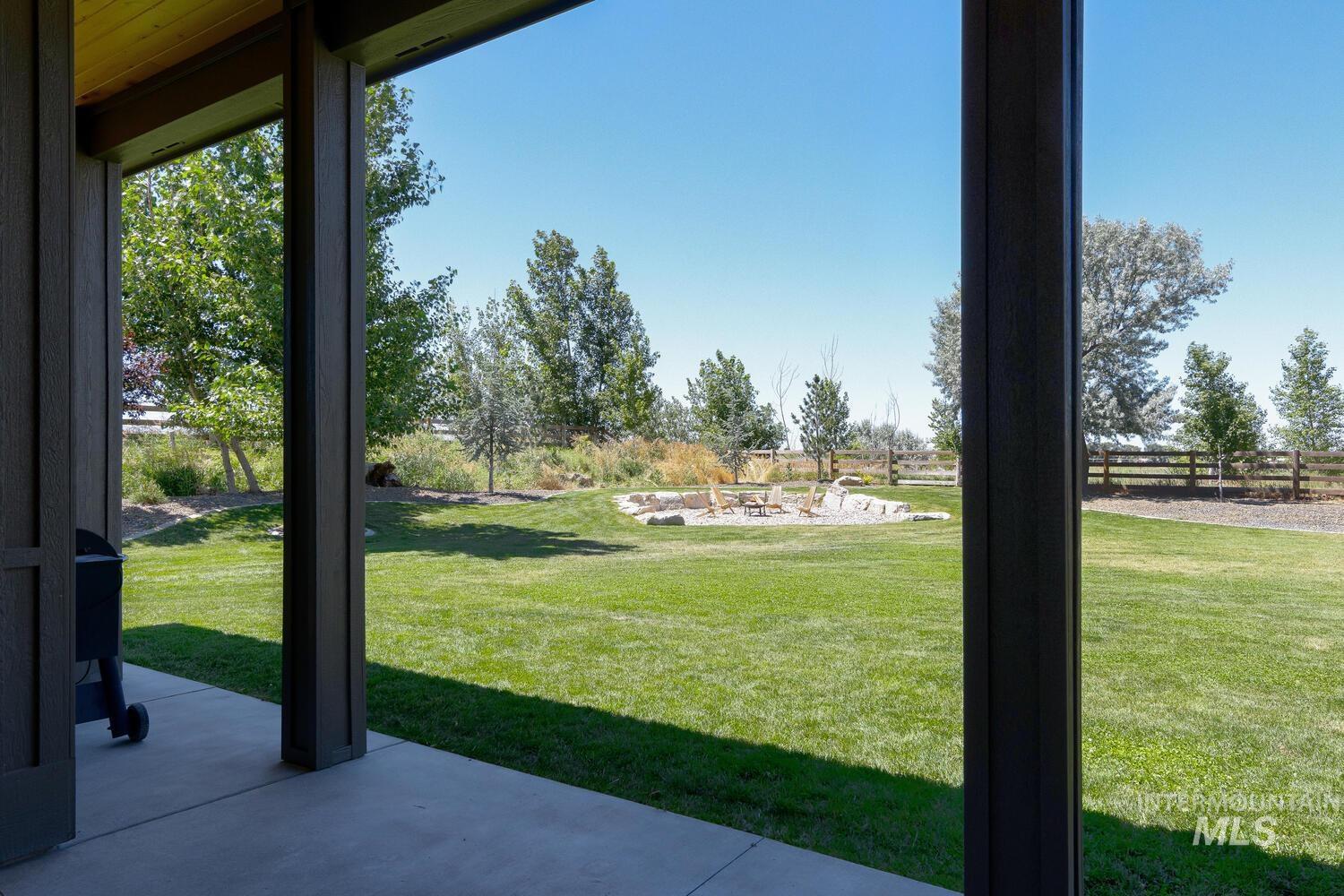 View of yard featuring an outdoor fire pit and a patio