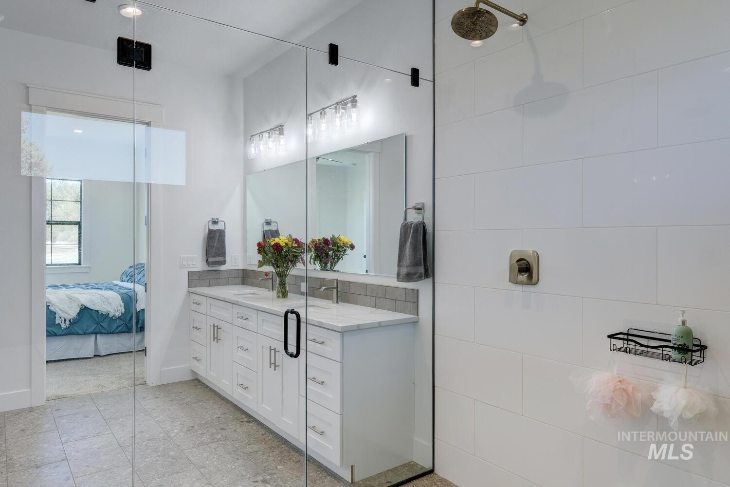 Ensuite bathroom featuring vanity and a shower