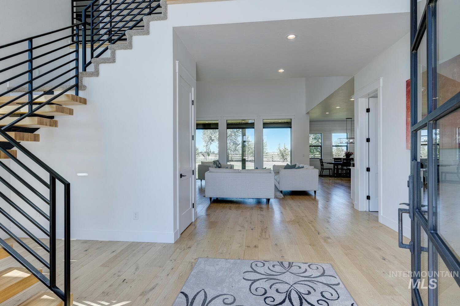 Entryway with hardwood / wood-style floors, stairs, and recessed lighting