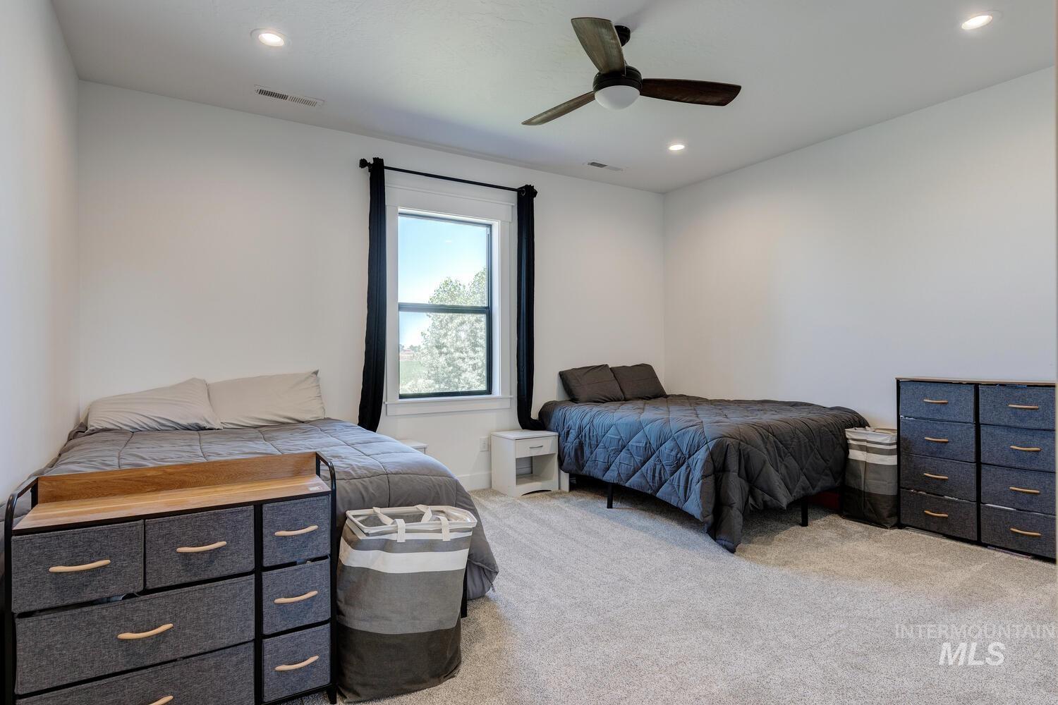 Bedroom with light colored carpet, recessed lighting, and ceiling fan