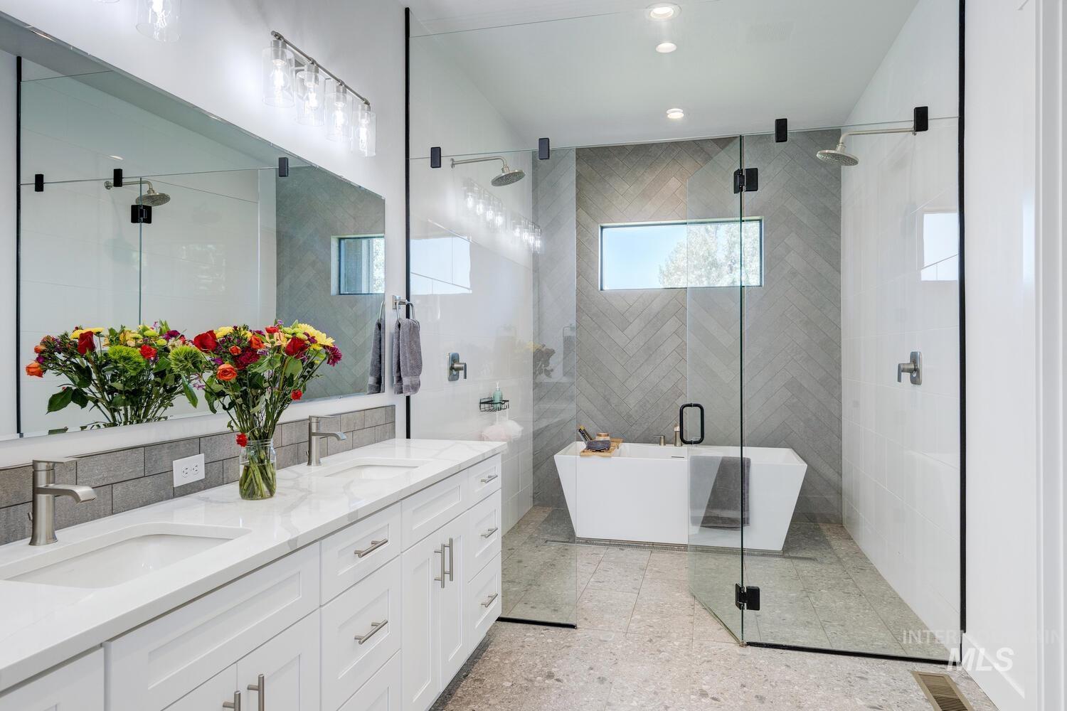 Full bathroom with a soaking tub, double vanity, a stall shower, and recessed lighting
