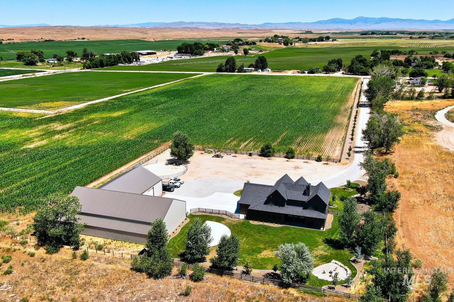 Aerial view of sparsely populated area featuring abundant farmland and a mountainous background