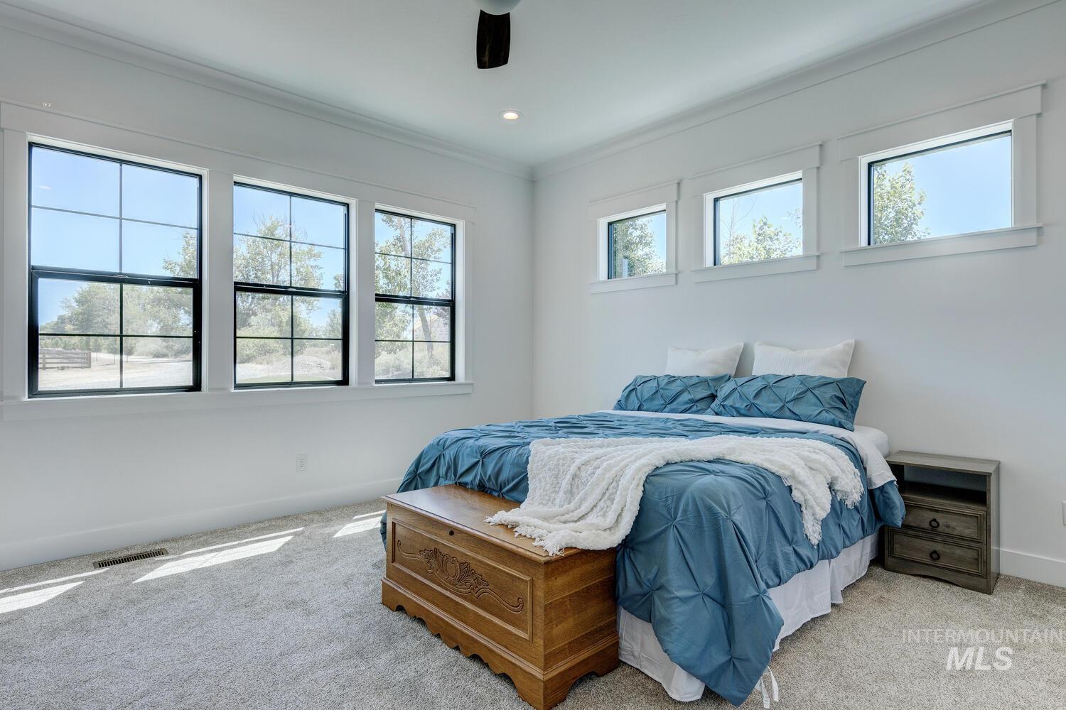 Bedroom with light colored carpet, ornamental molding, a ceiling fan, and recessed lighting