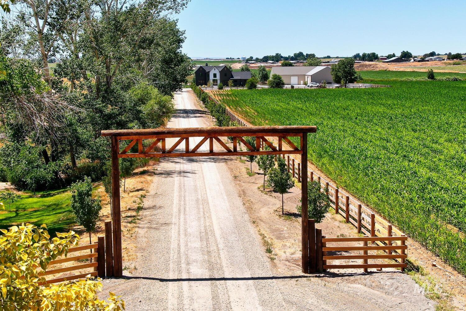 Deck with a lawn, a rural view, and dirt driveway