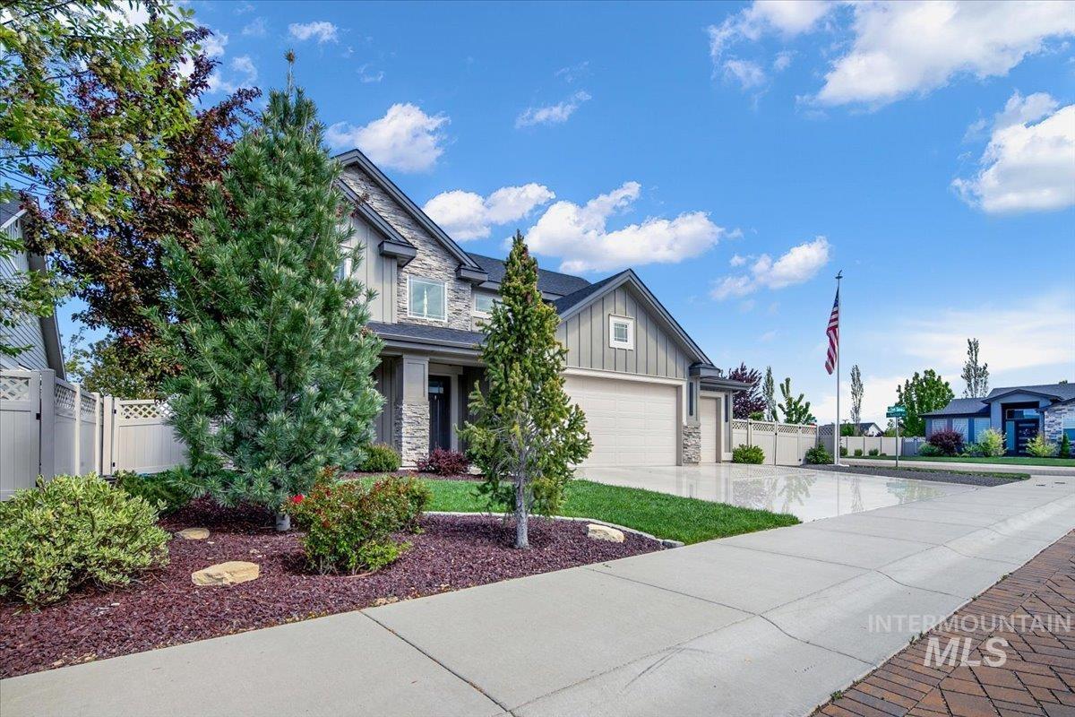 Exterior featuring stone and siding finishes with a prominent two-car garage