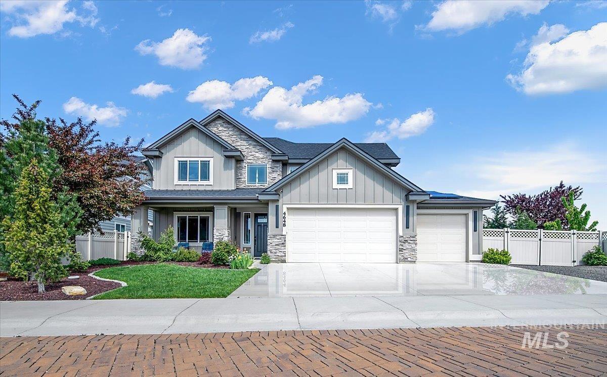 Modern two-story home featuring a combination of horizontal siding and stone veneer