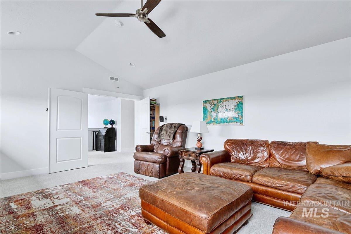 Vaulted ceiling with recessed lighting and a ceiling fan
