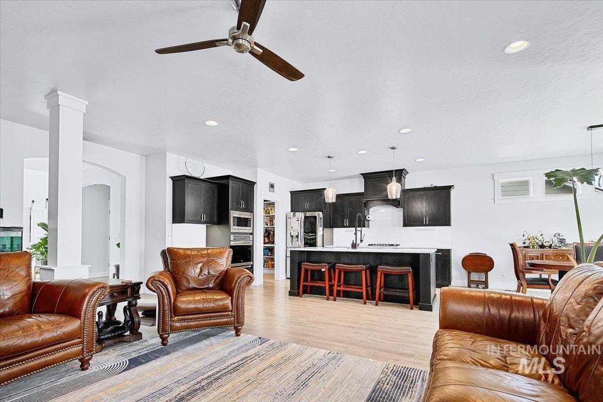 Open-concept living space with light wood-finish flooring