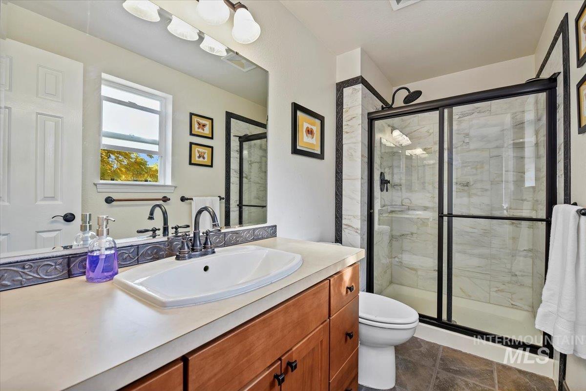 Full bath featuring vanity and a stall shower