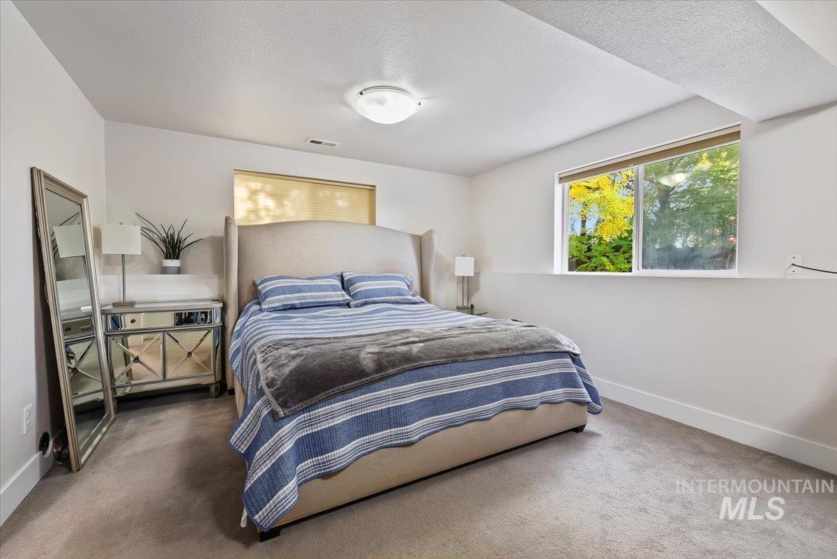 Bedroom featuring a textured ceiling and carpet