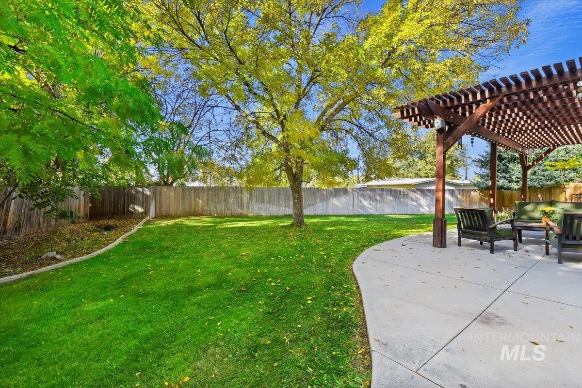 Fenced backyard featuring a pergola, a patio area, and outdoor lounge area