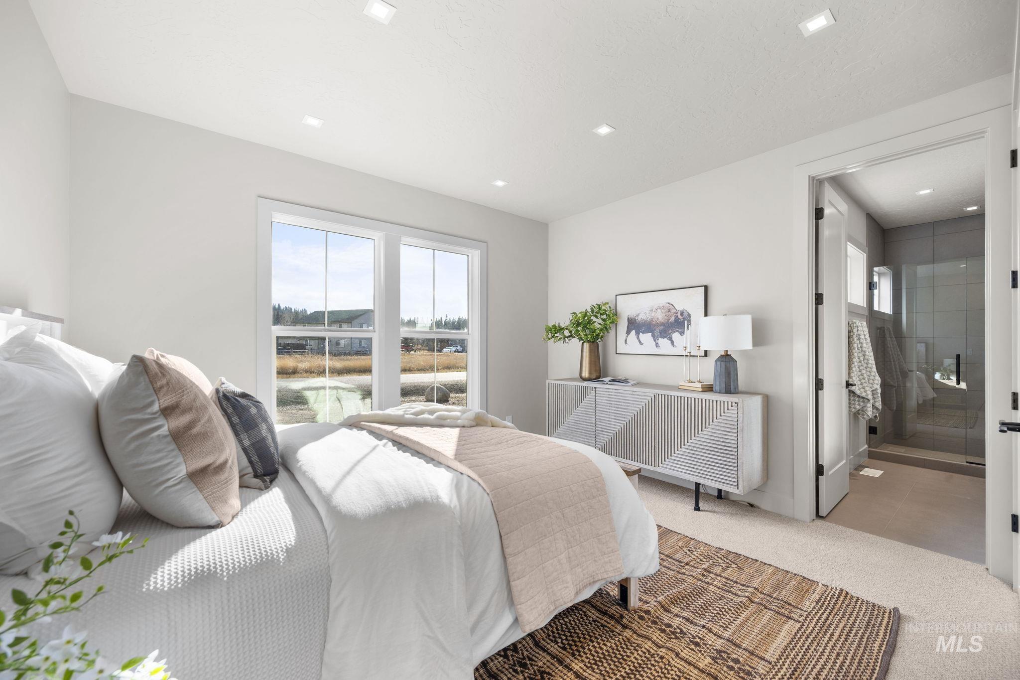 Jr Suite - Main Floor Bedroom with multiple windows, carpet flooring, and ensuite bathroom