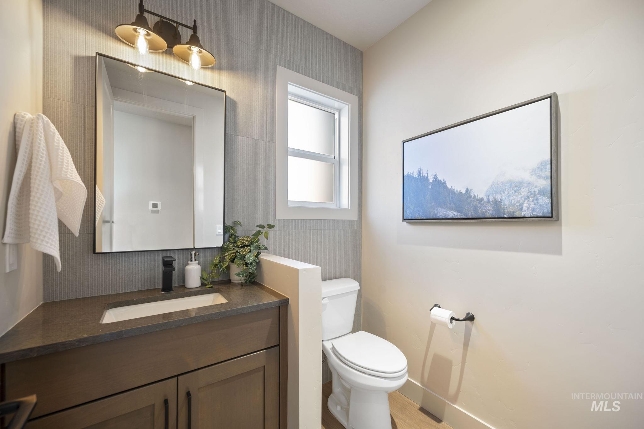 Half bath featuring vanity and toilet - Main Floor