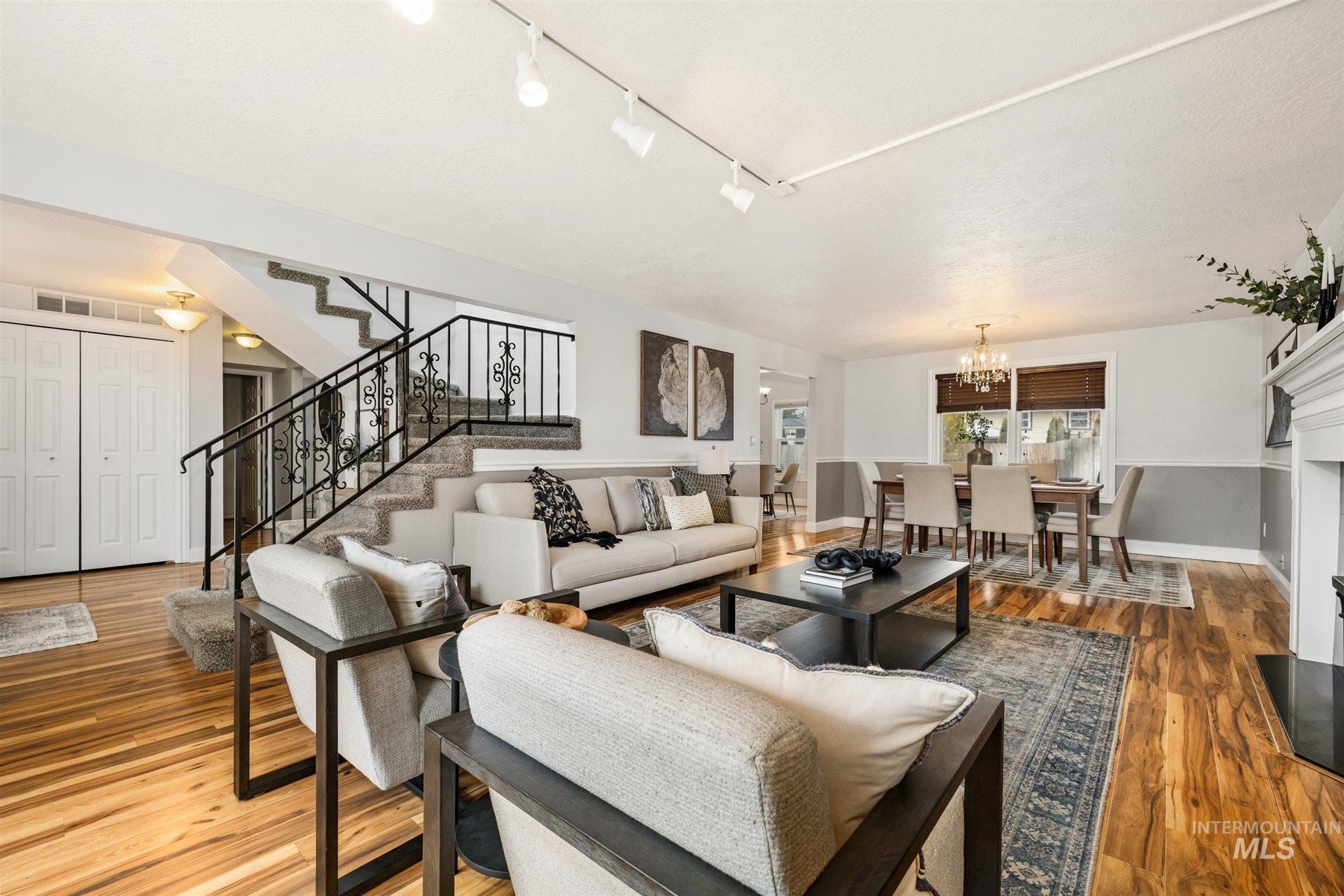 Living room featuring wood-type flooring and a chandelier