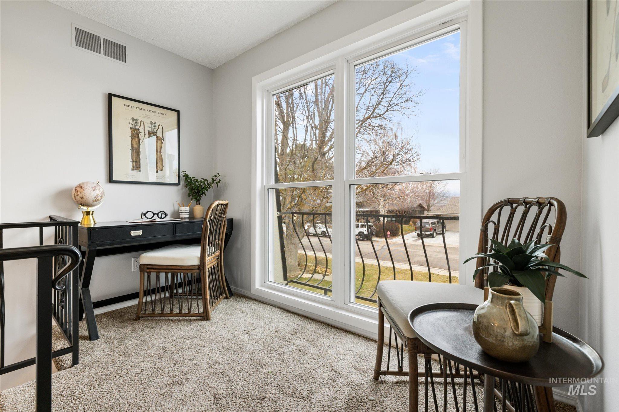 Office area featuring light carpet