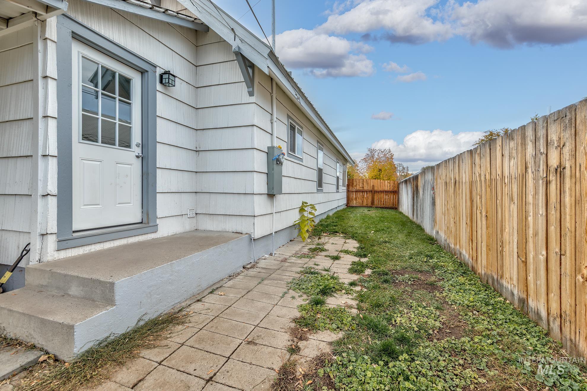 View of property exterior featuring a fenced backyard