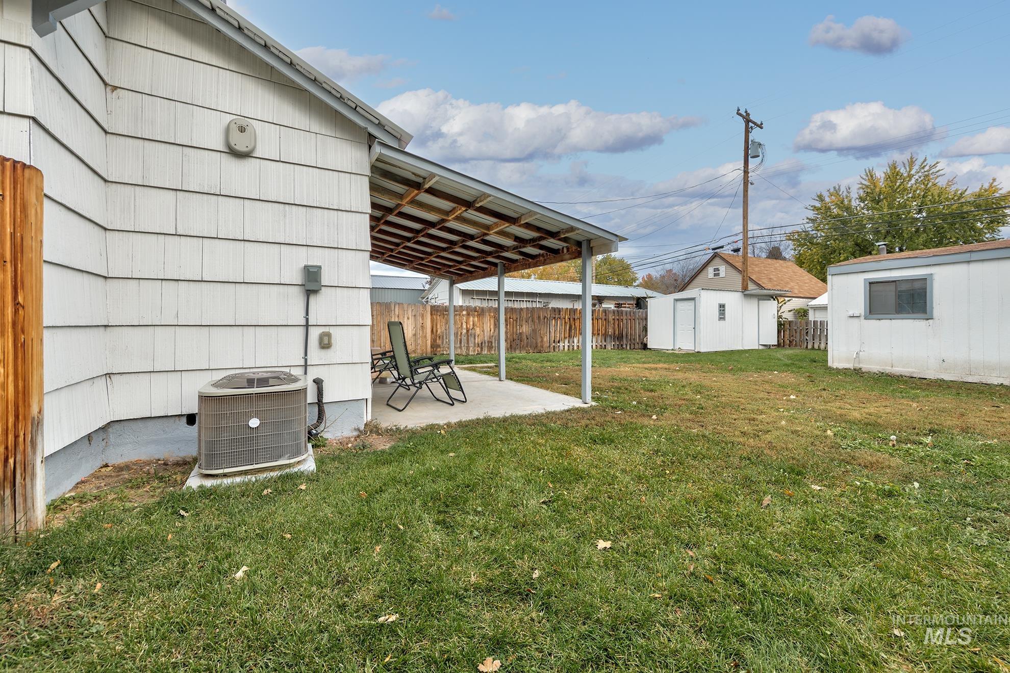 View of yard featuring a patio and a shed