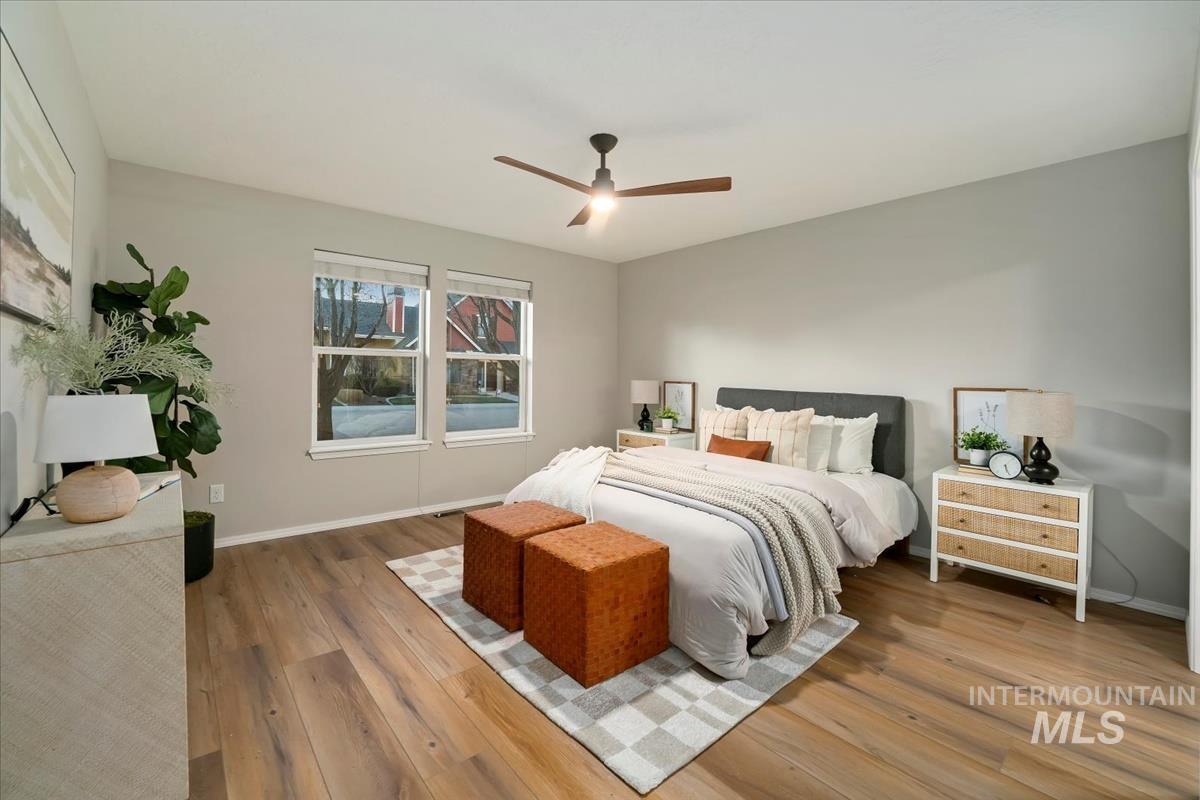 Bedroom with wood-type flooring and a ceiling fan