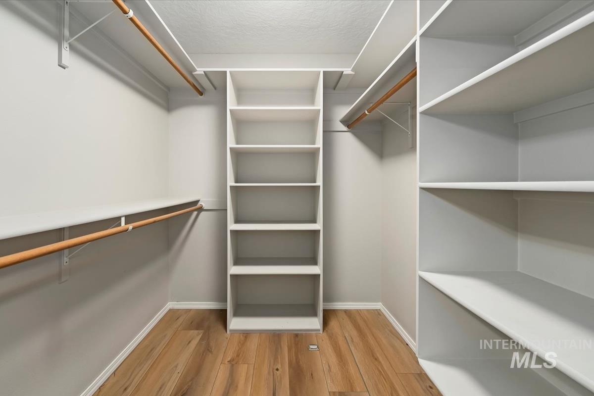 Spacious closet featuring light wood-type flooring