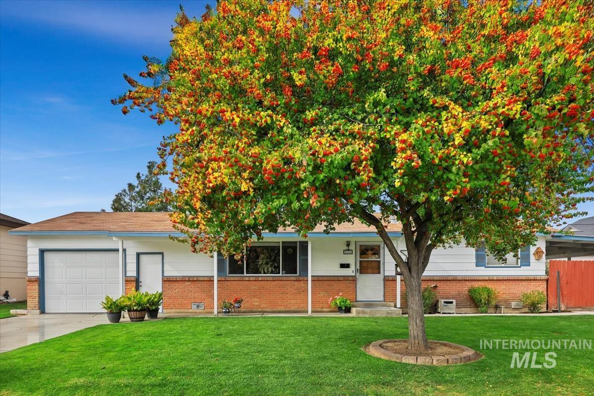 View of front of property featuring a front yard, brick siding, and covered porch