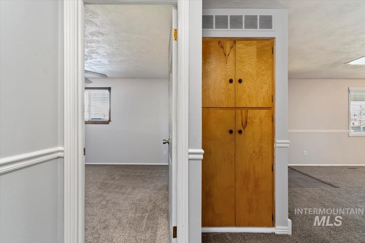 Corridor featuring carpet and a textured ceiling