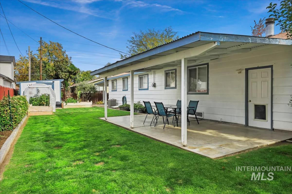 Back of property featuring a patio area and an outdoor structure