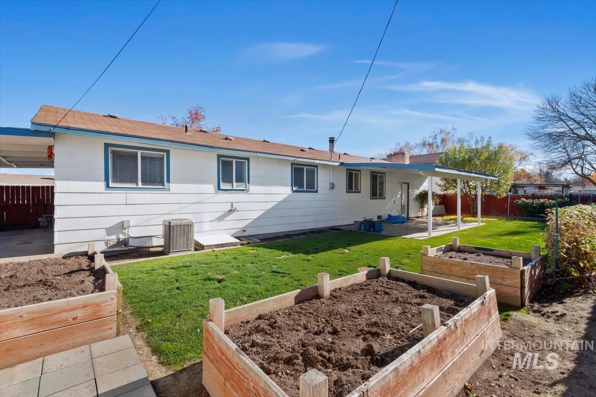 Back of house featuring a vegetable garden and a patio
