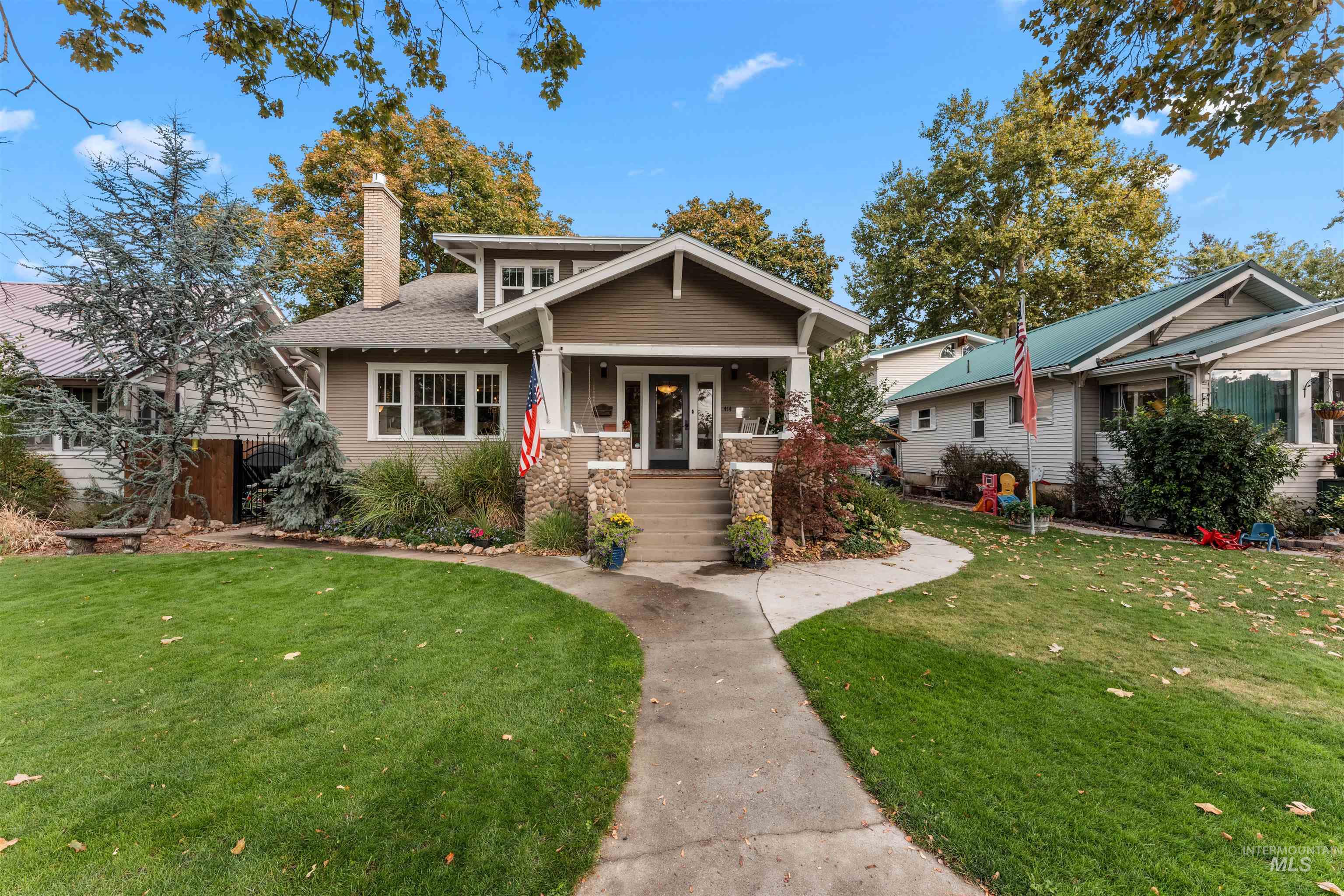 View of front of house featuring a porch, a front lawn, and a chimney