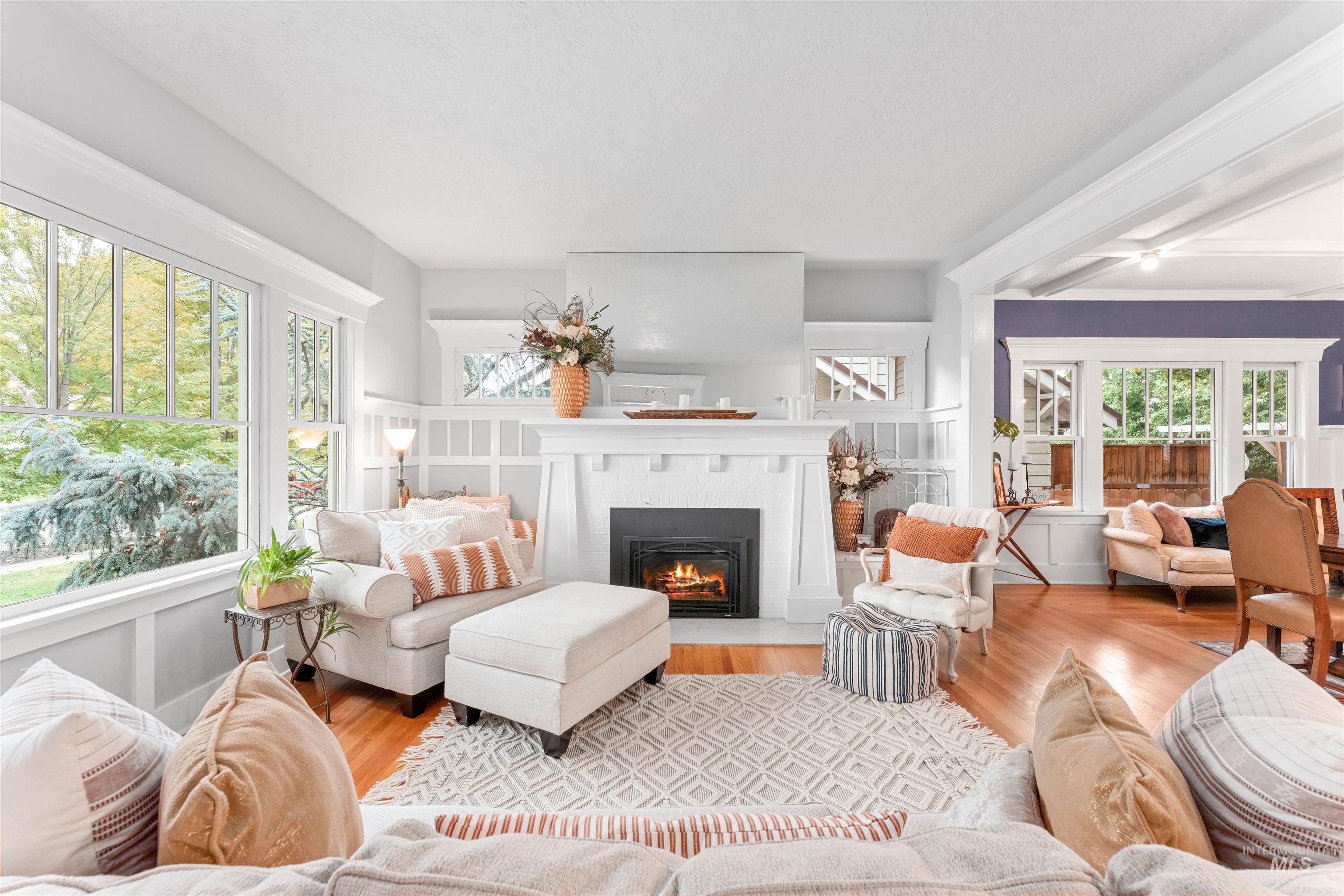 Living room featuring a fireplace with flush hearth and wood finished floors