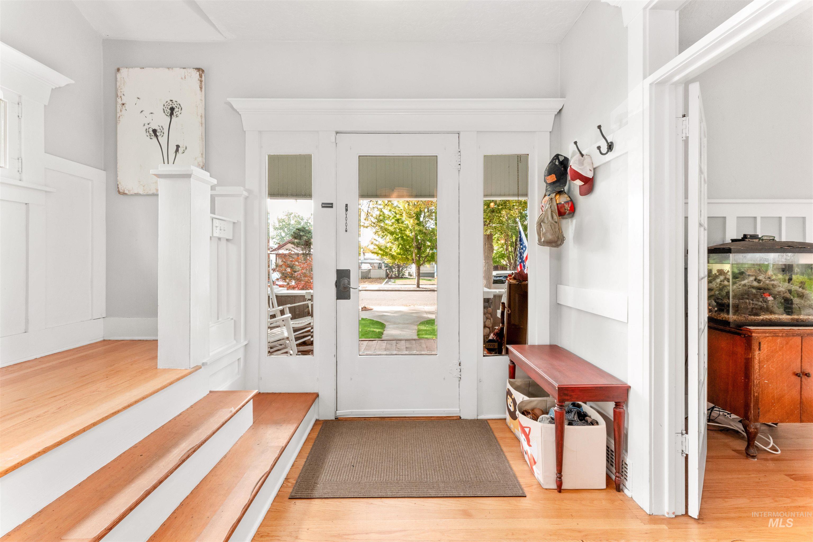 Doorway featuring wood finished floors and baseboards