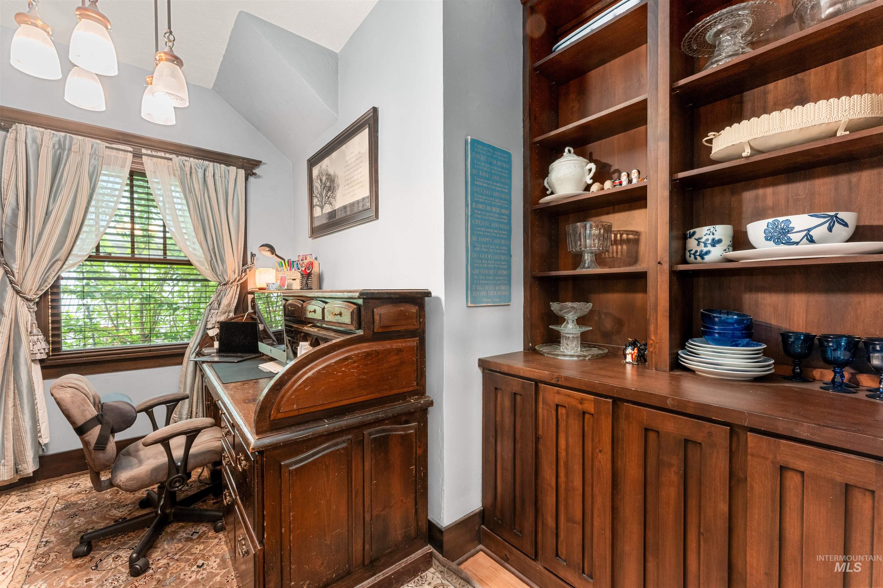 Home office featuring baseboards and lofted ceiling