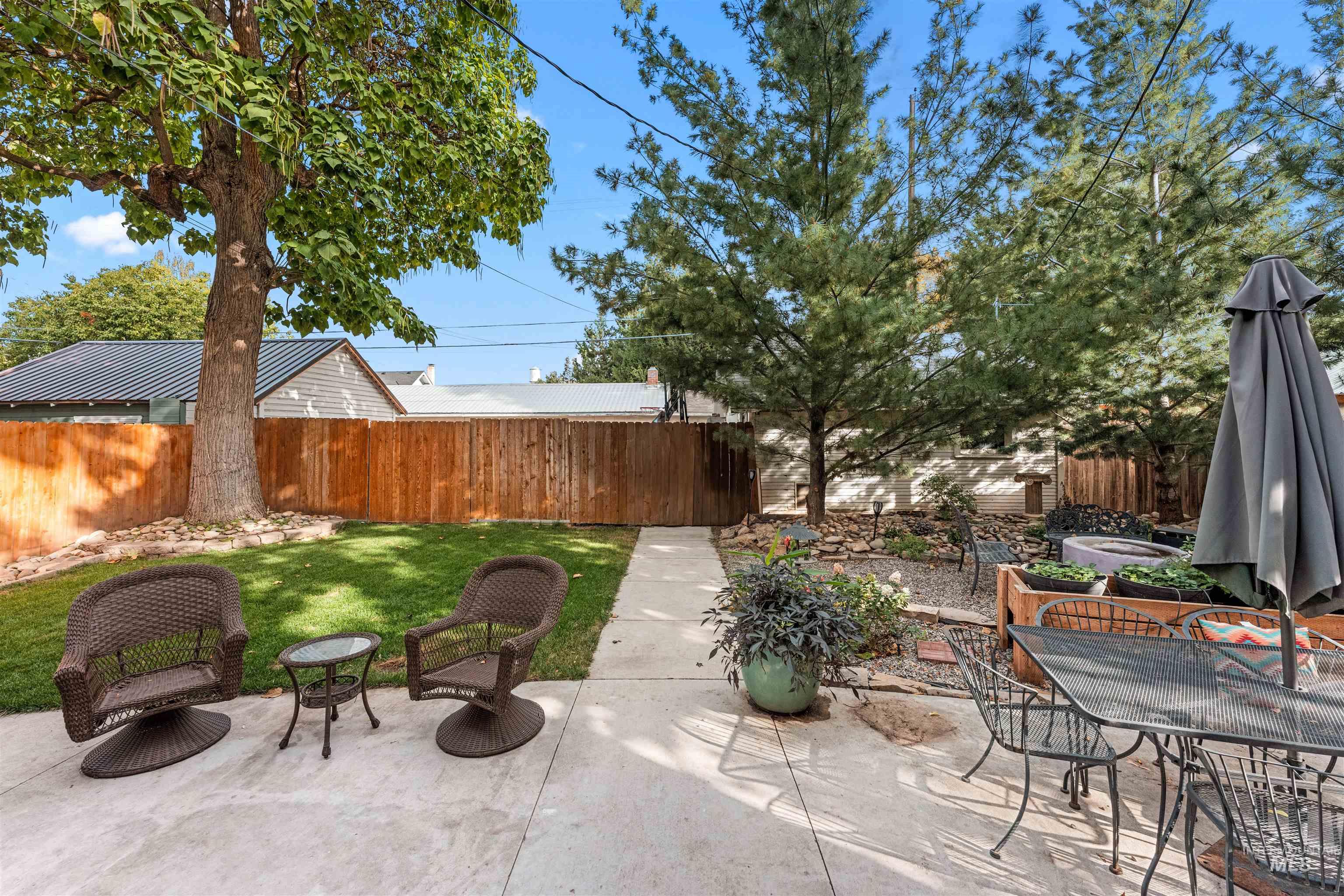 Fenced backyard with a patio area and outdoor dining area