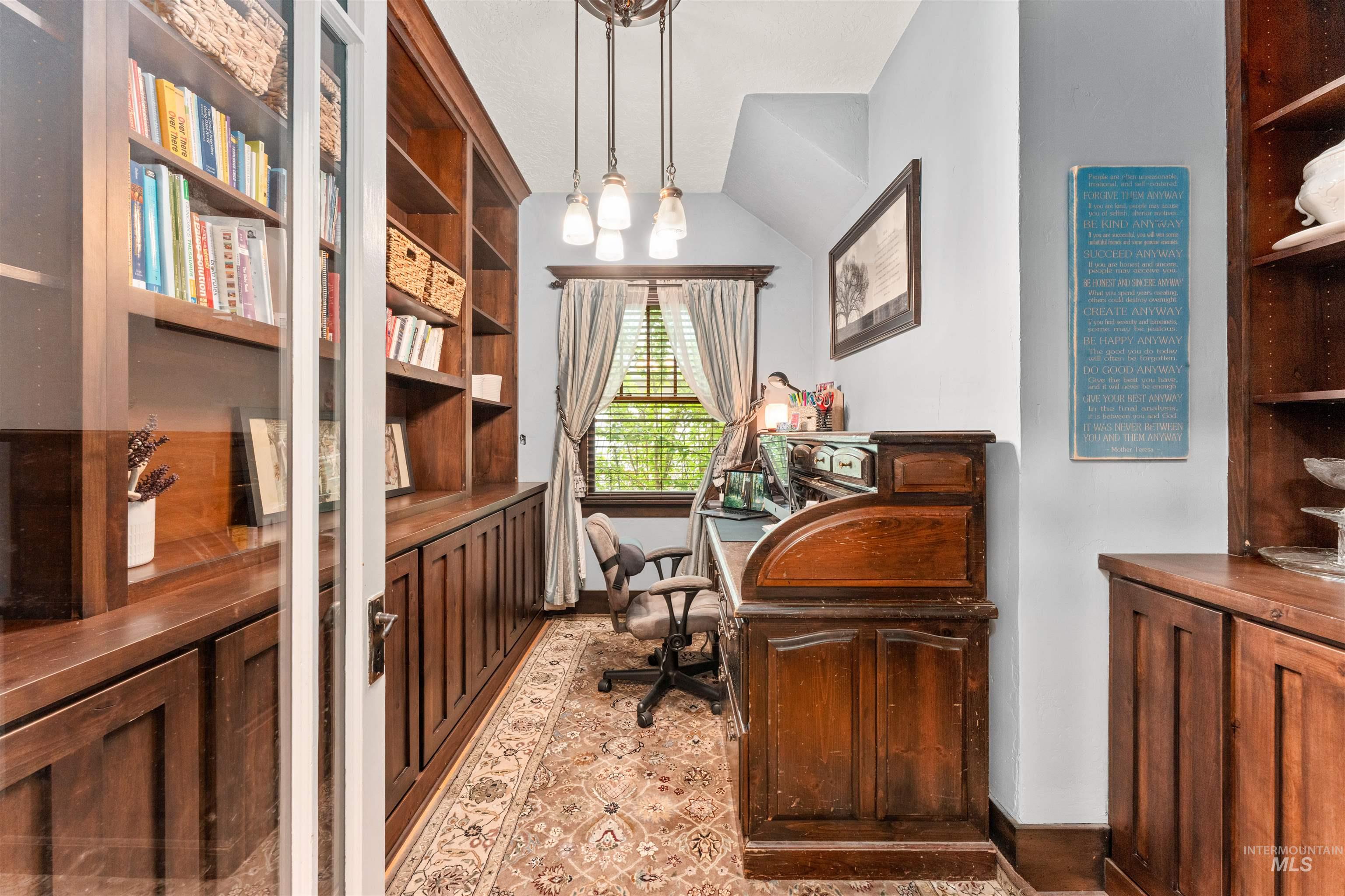 Office with lofted ceiling and baseboards