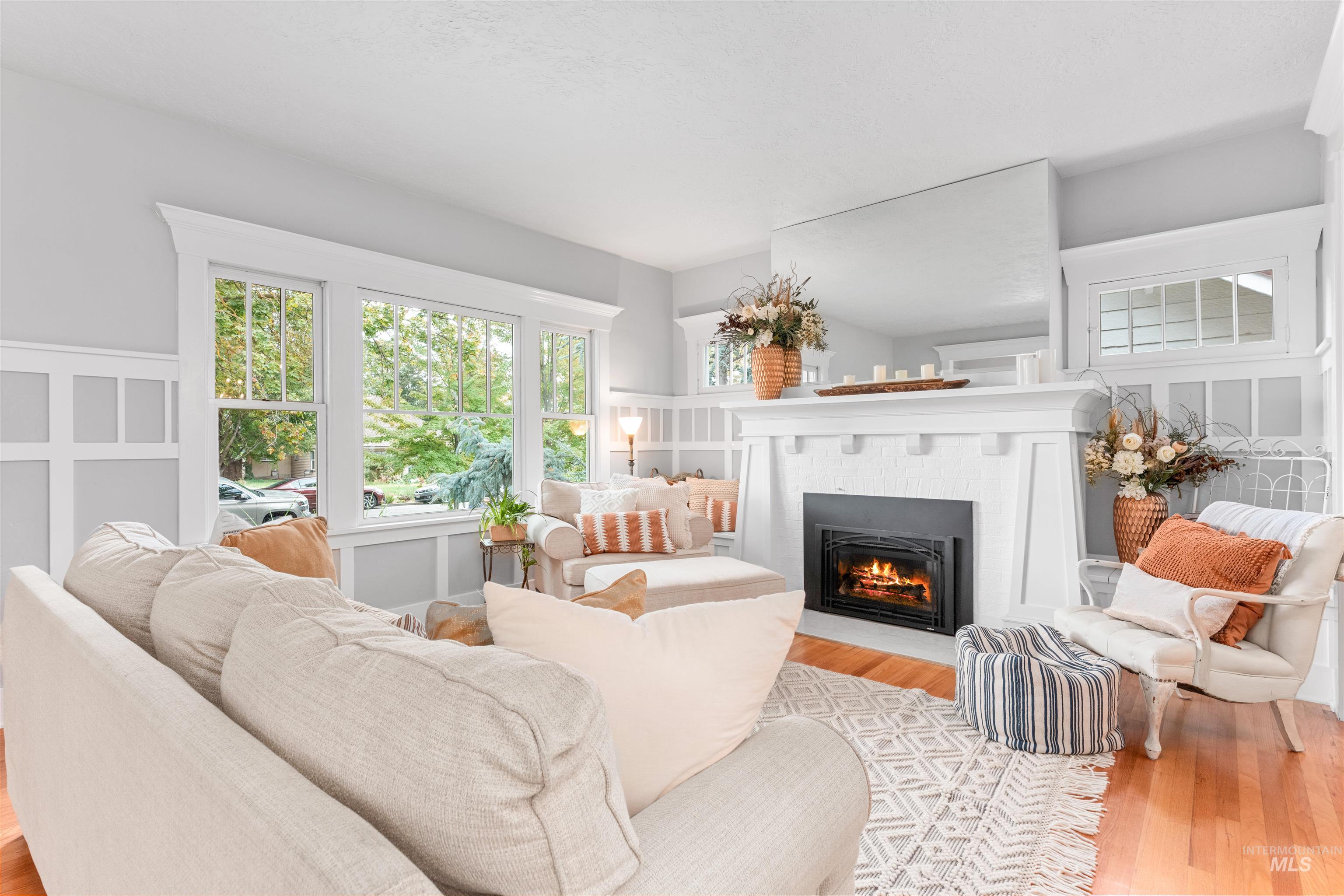 Living area featuring wood finished floors and a fireplace with flush hearth