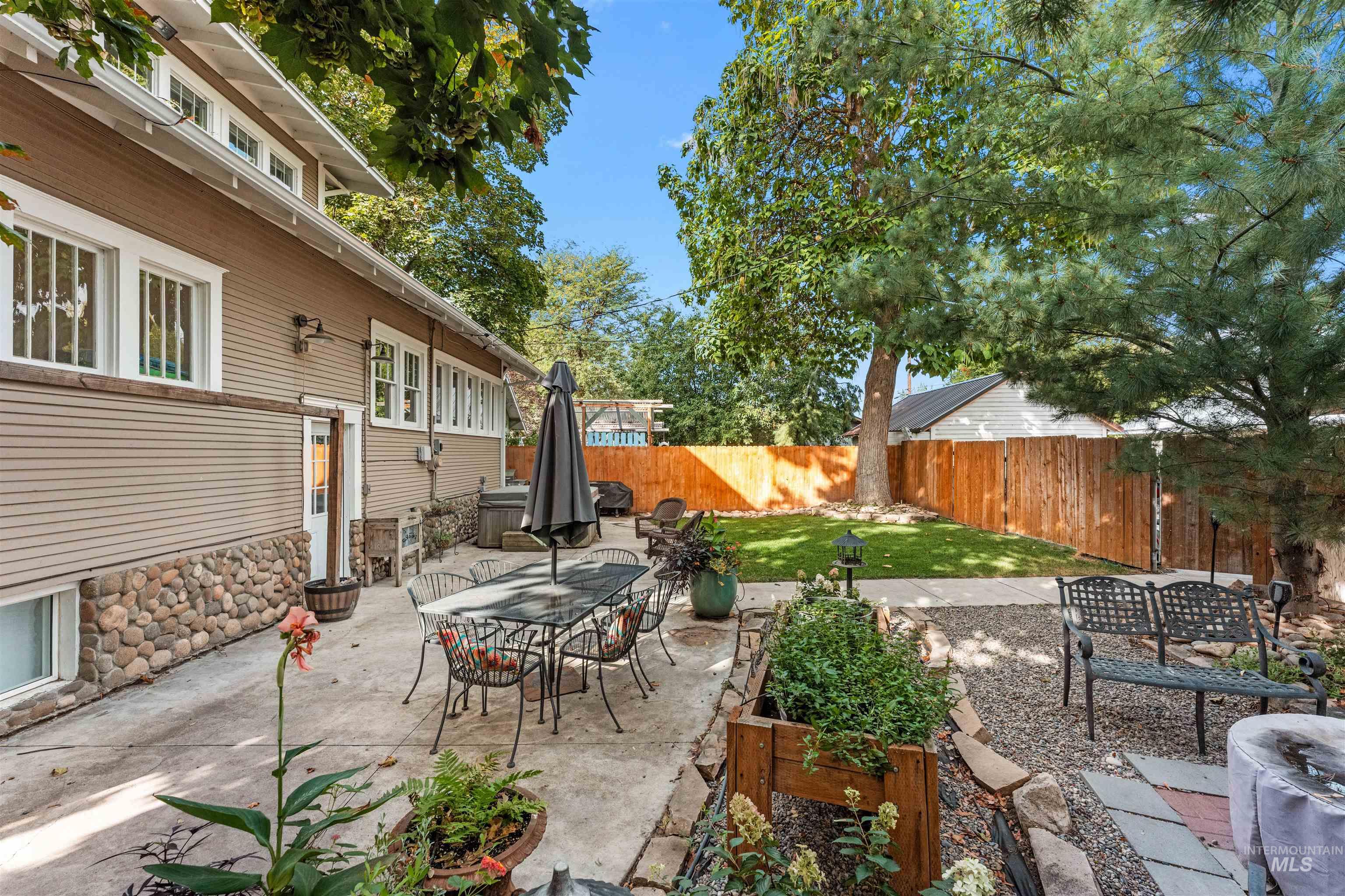 Fenced backyard featuring a patio area and outdoor dining area